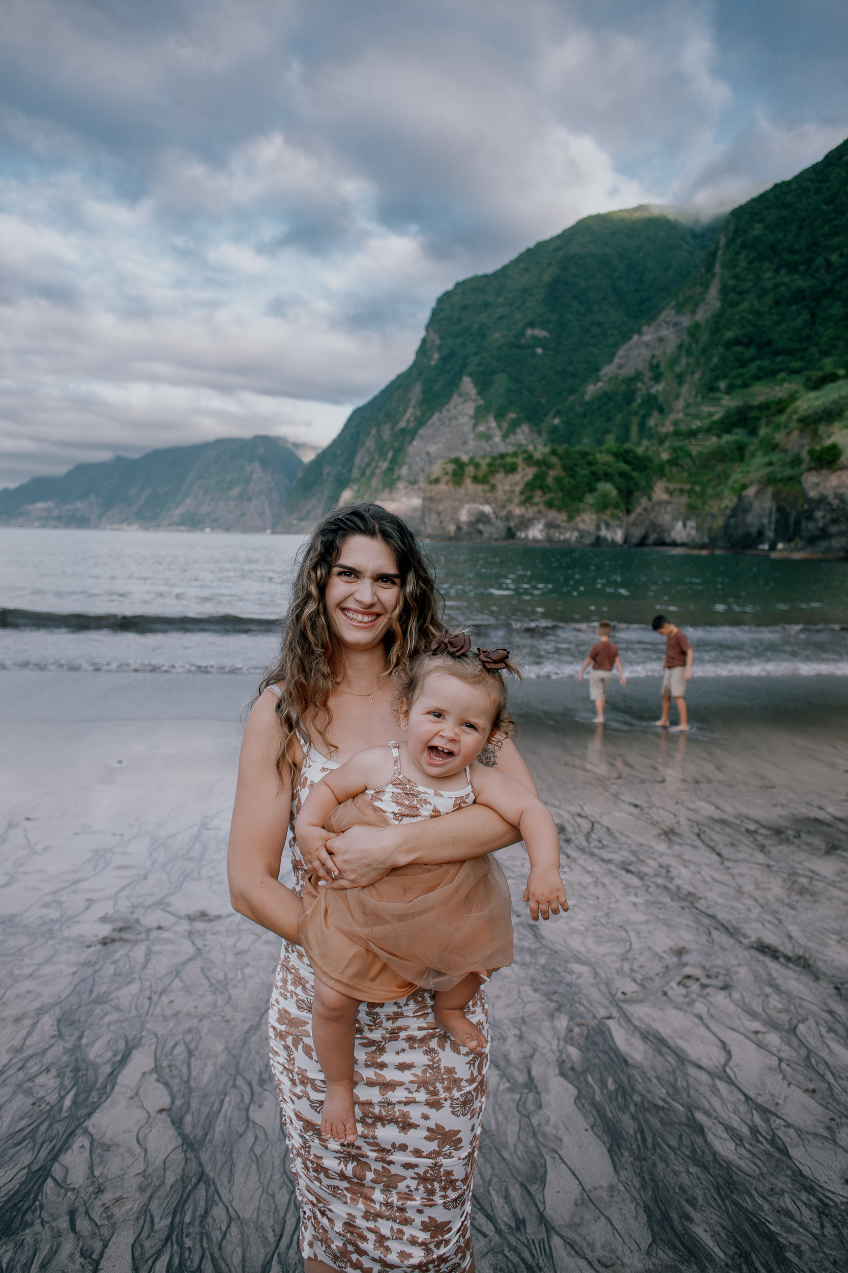 The two boys walking the beach under a wide grey sky, Seixal, Madeira
