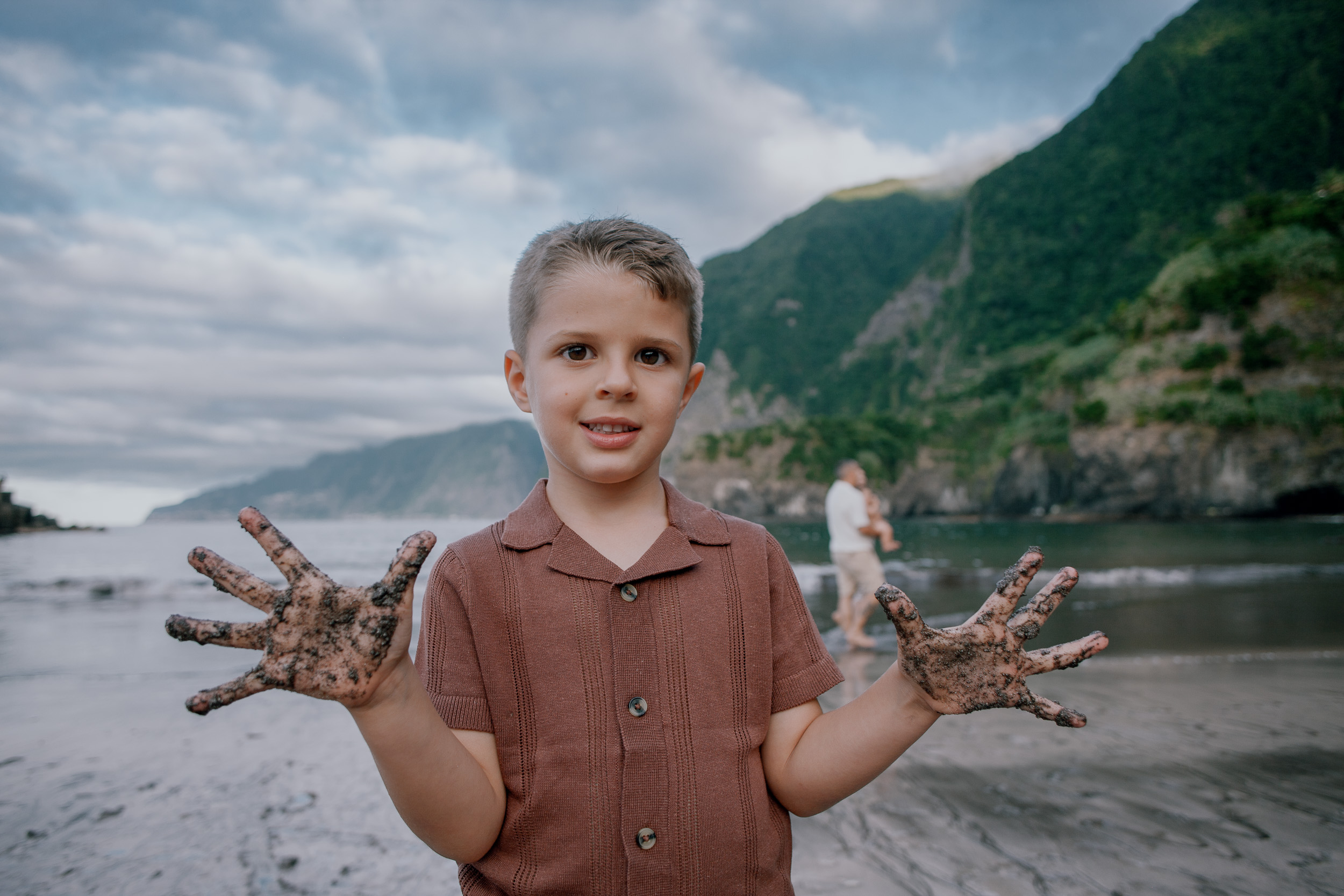 The boy proudly showing his sand-covered hands, Seixal Beach, Madeira