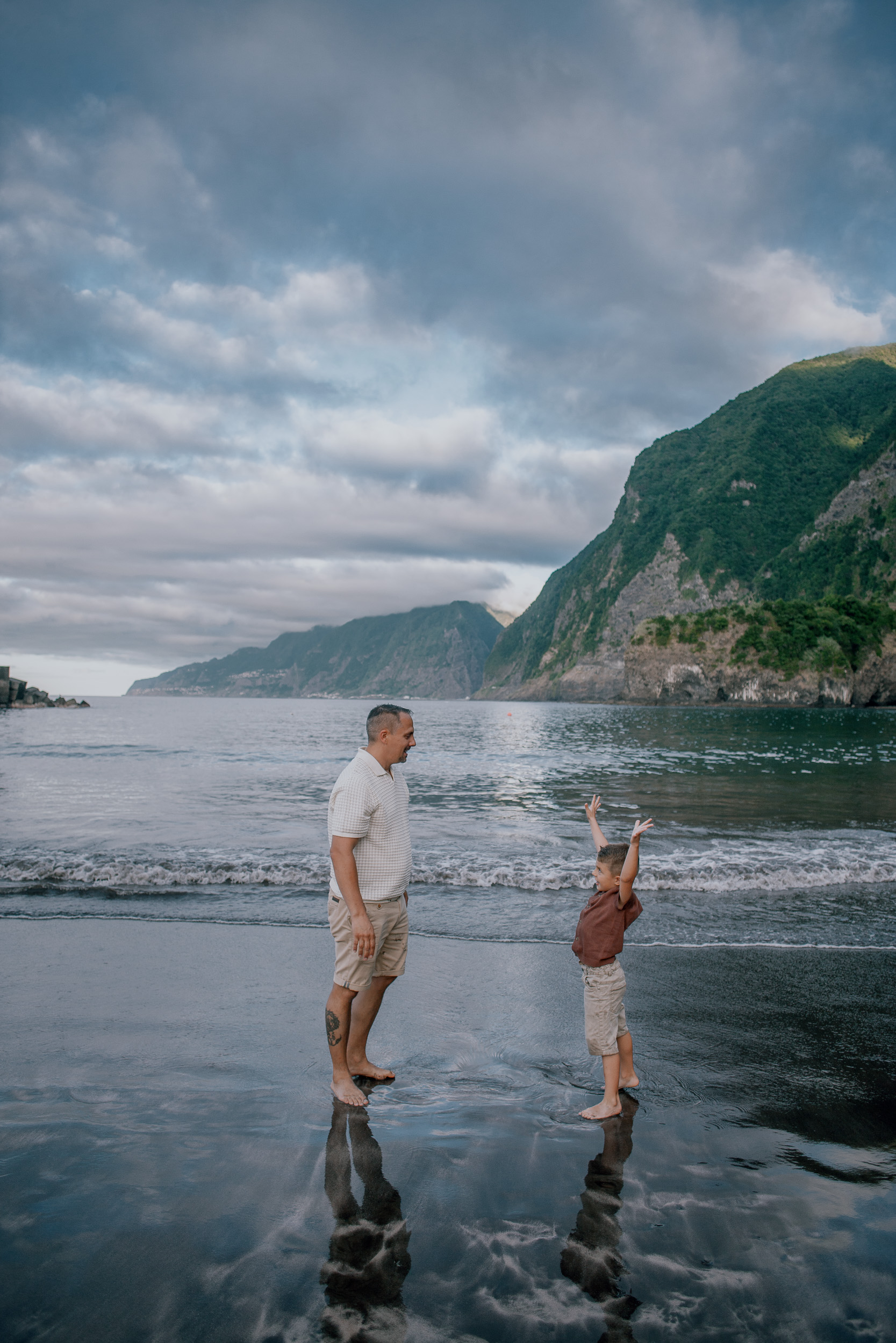 Dad reaching for his son at the waterline, Seixal, Madeira