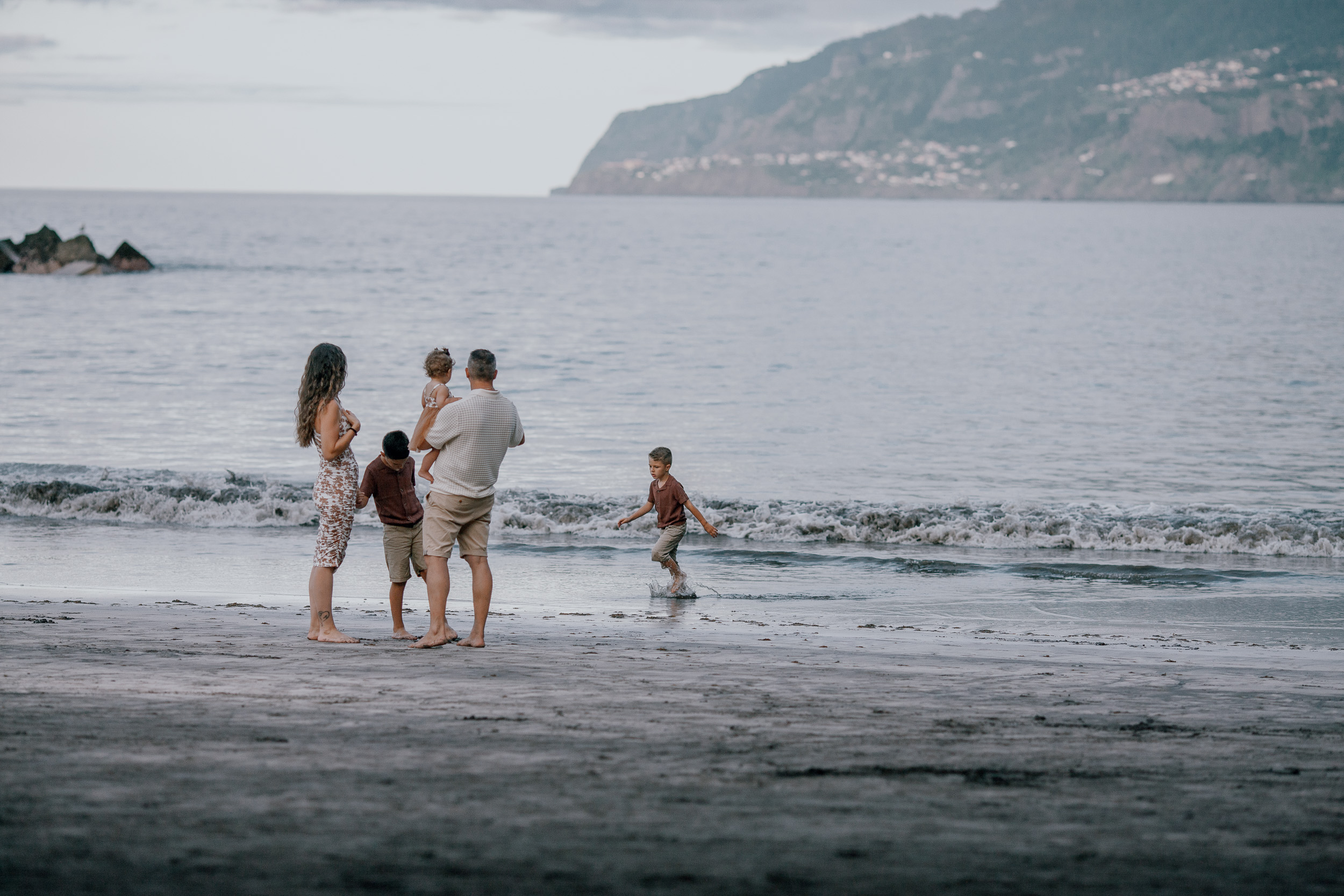 Mother with the baby and the older boy at the shore, Seixal, Madeira