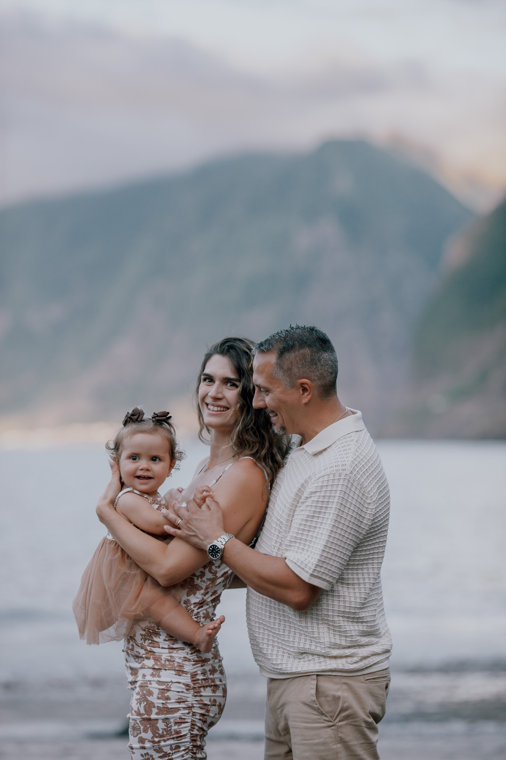 The family standing together at the surf at dusk, Seixal Beach, Madeira