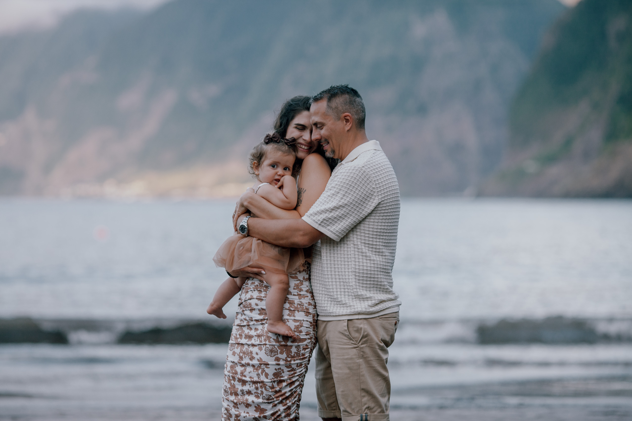 Mum and dad with the baby between them at dusk, Seixal, Madeira