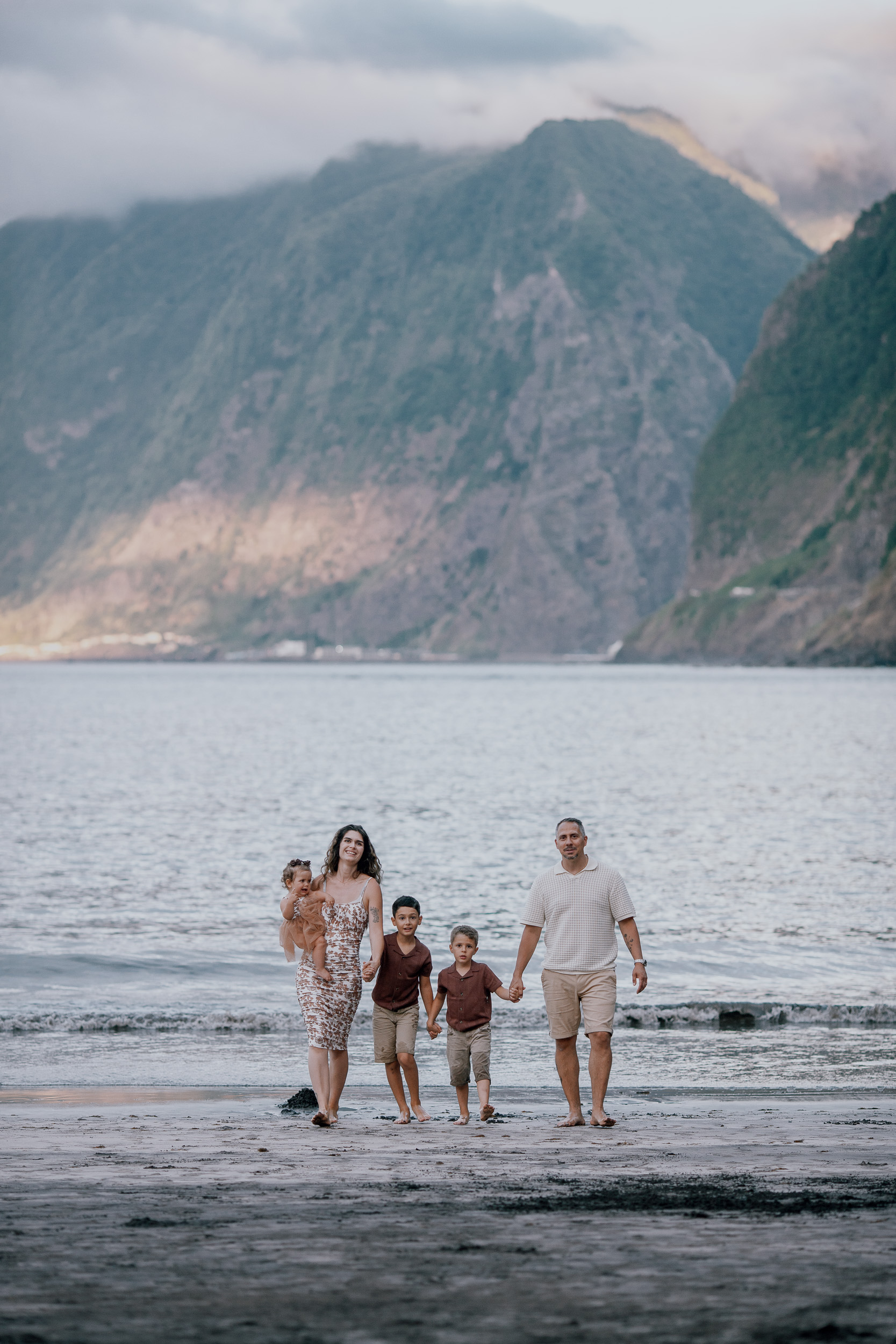 Parents and kids walking the shore toward the camera, Seixal Beach, Madeira
