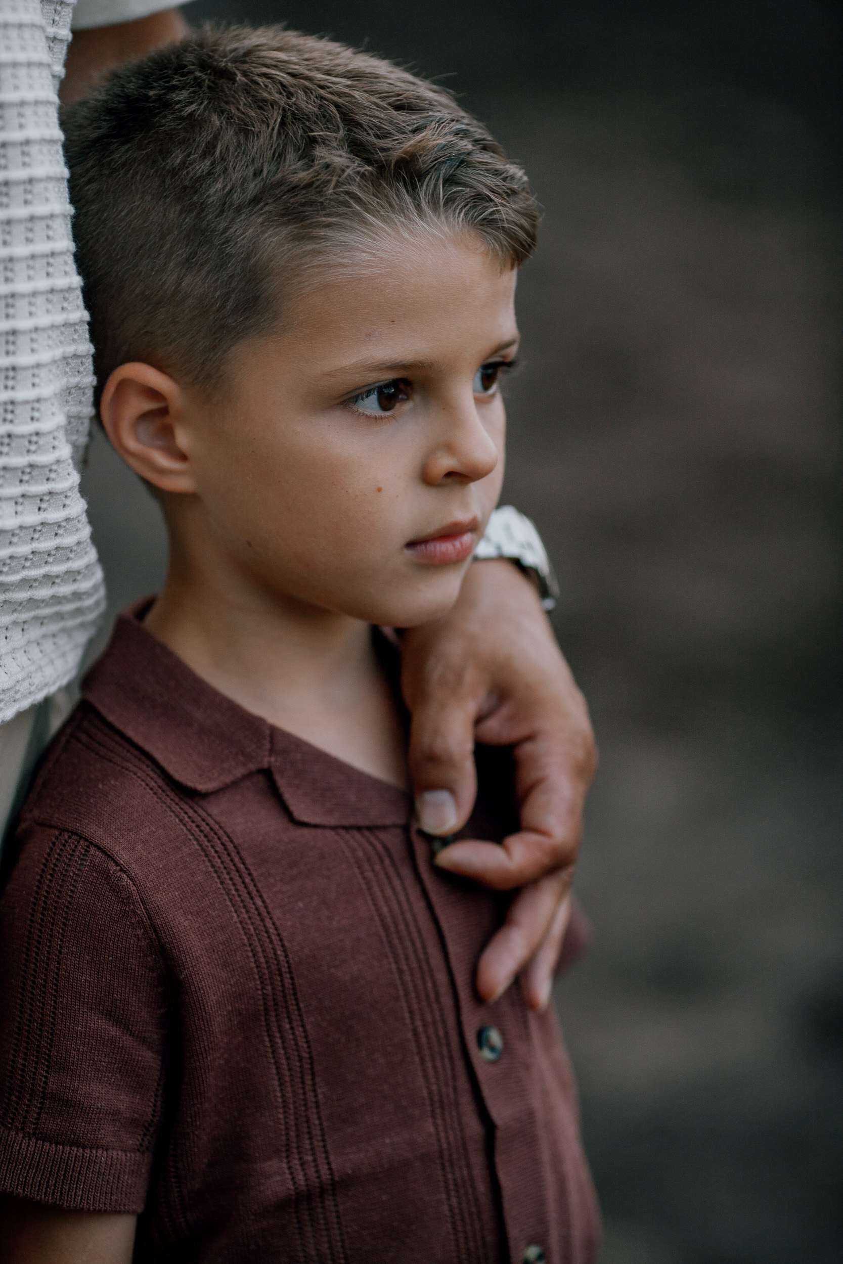 The older son looking off camera, mum's hand on his shoulder, Seixal, Madeira
