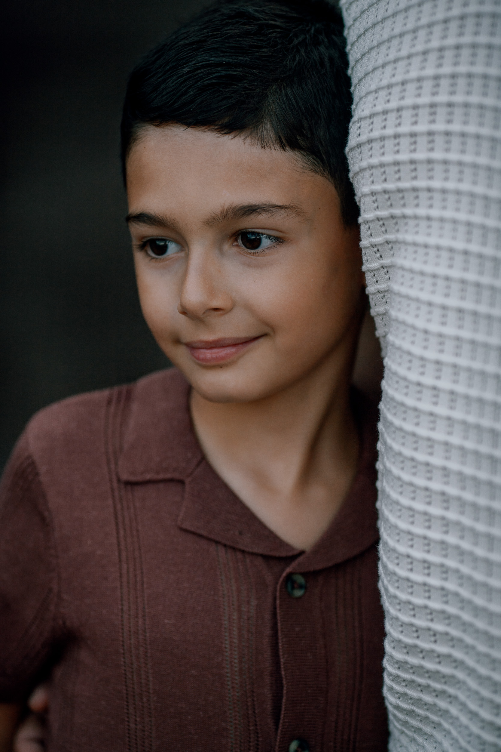 The older boy half-hidden behind mum's cardigan smiling, Seixal, Madeira