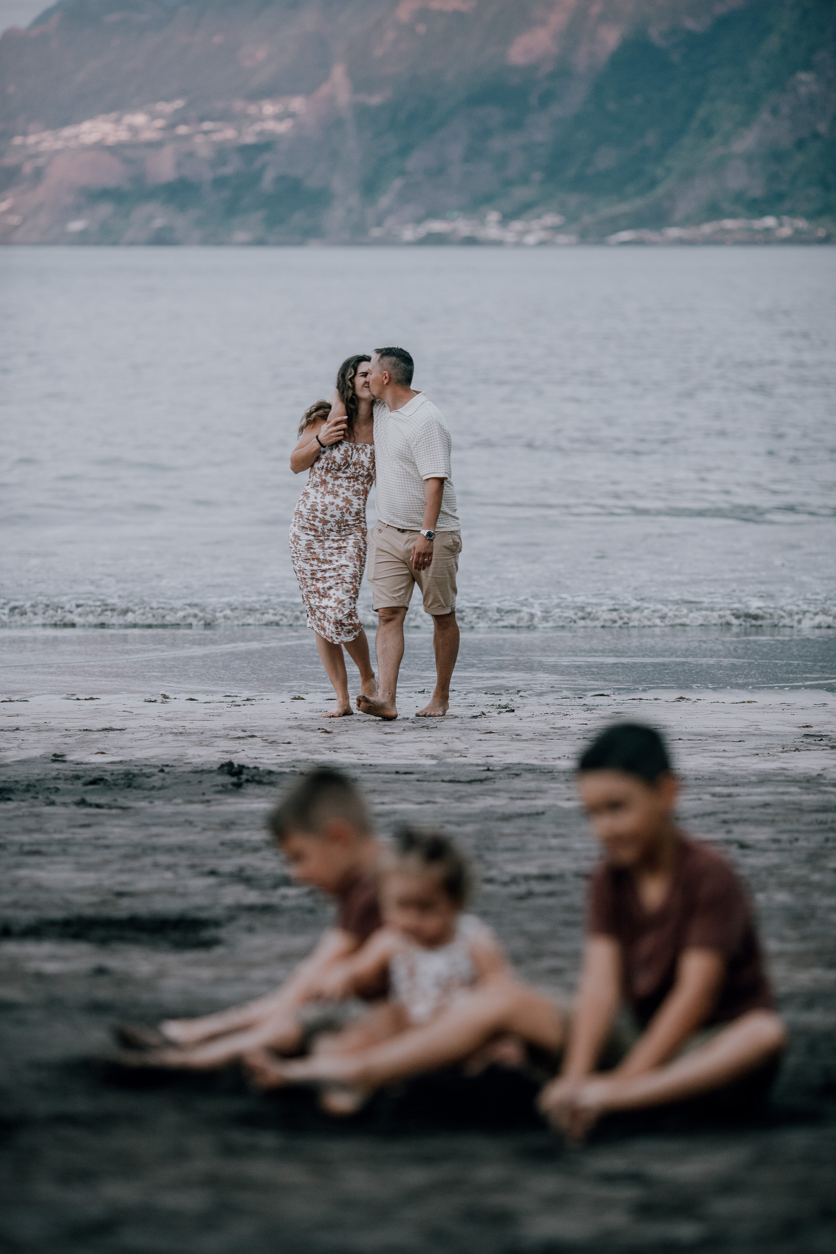 A kiss behind the kids at the darkening shore, Seixal Beach, Madeira