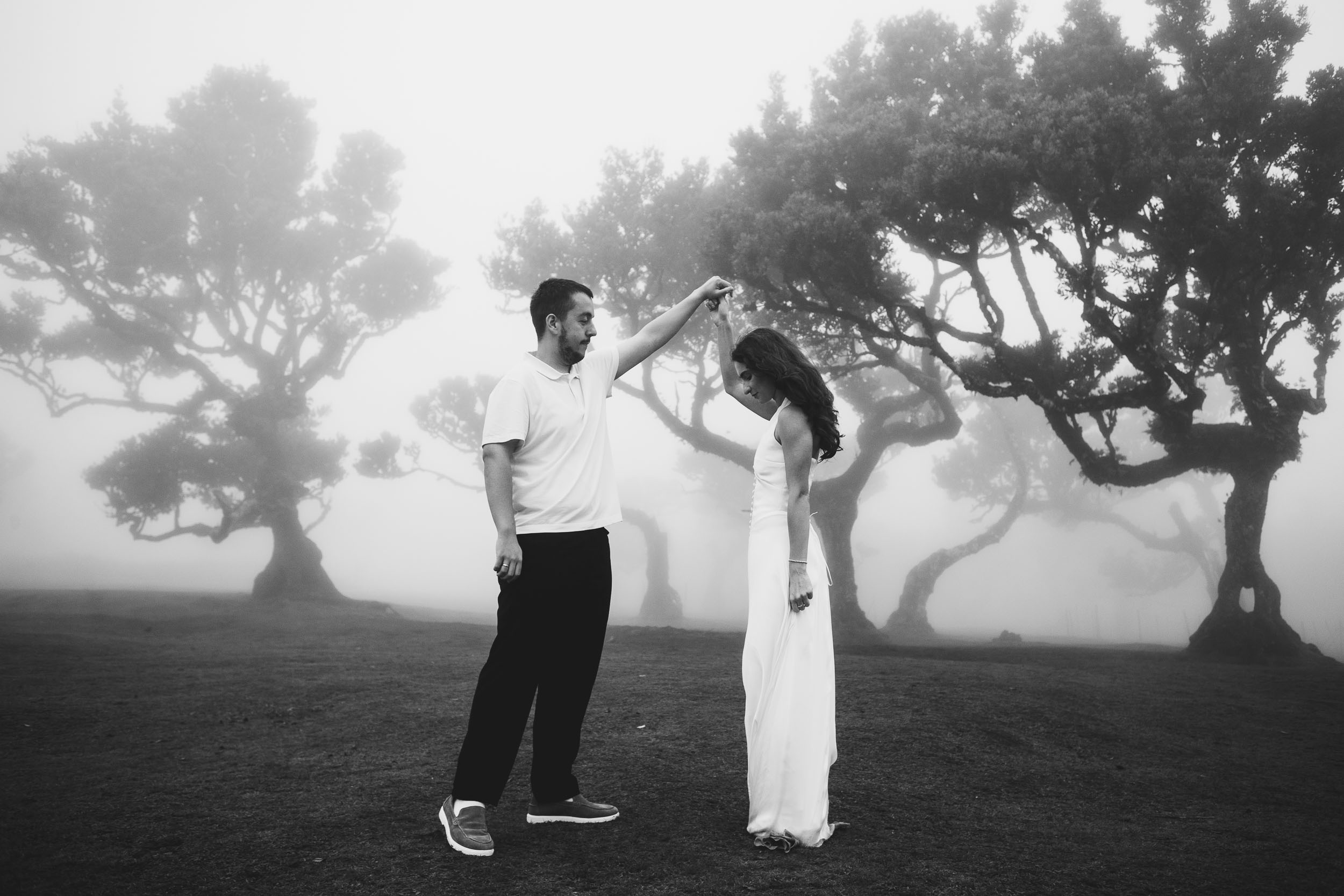 Black and white frame of him turning her under his arm, Fanal Forest, Madeira