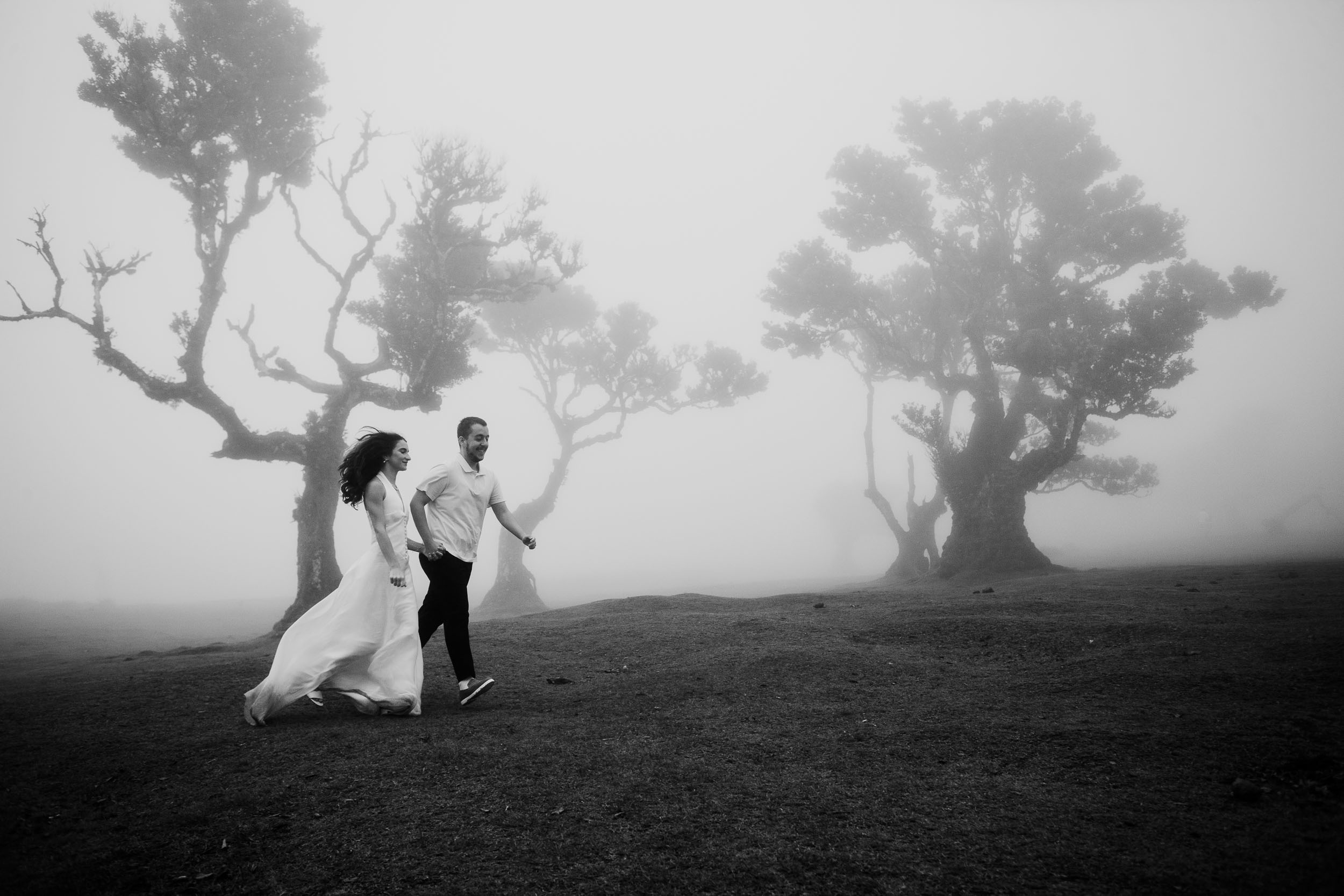 Black and white frame of the couple running across the plateau, Fanal Forest, Madeira