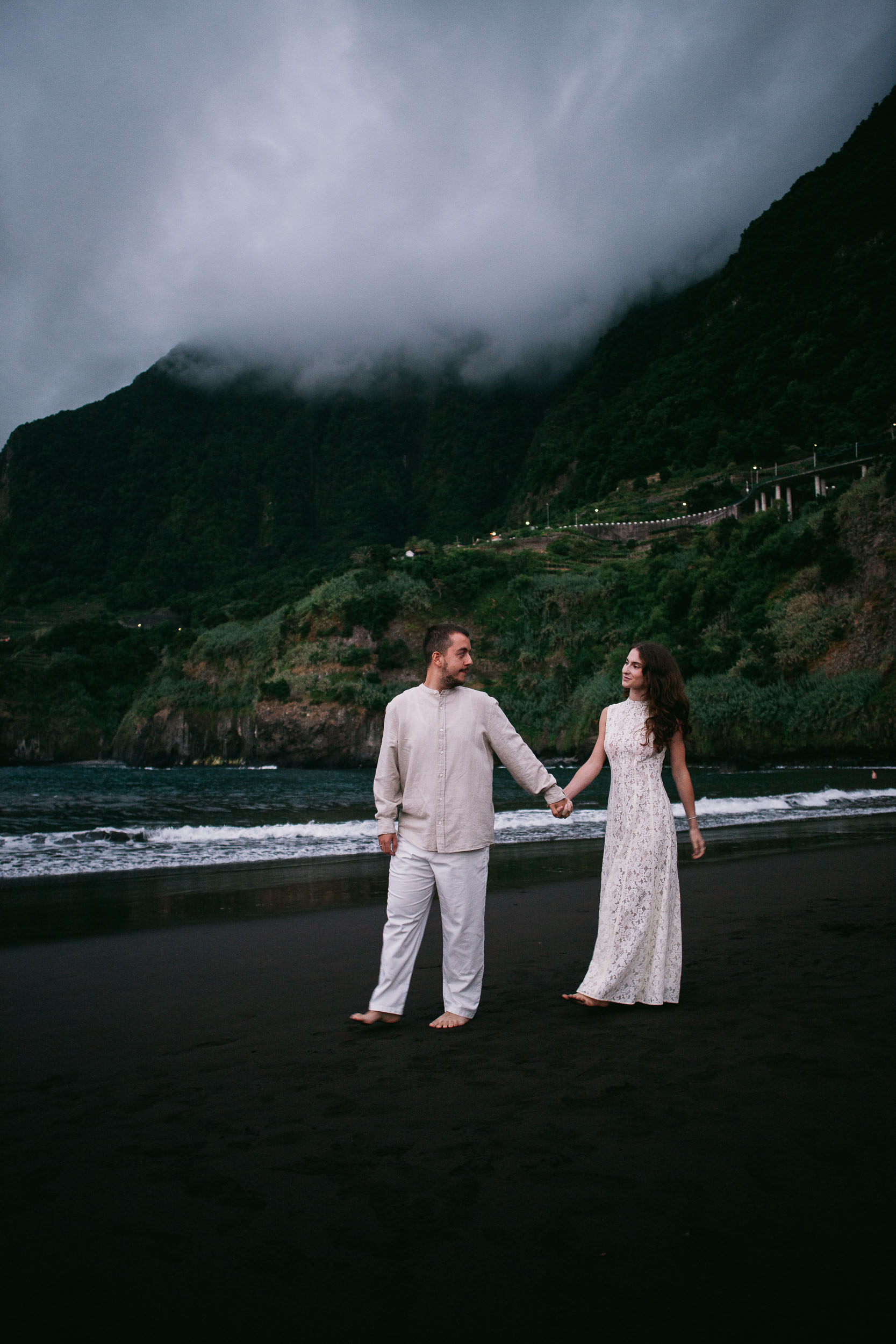 Cloud sitting on the cliffs above the black sand at dusk, Seixal Beach, Madeira