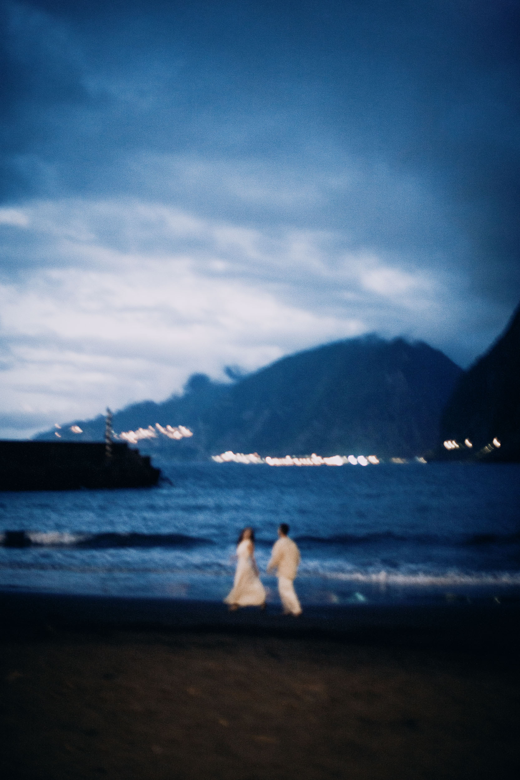 Village lights across the water after the sun has gone, Seixal Beach, Madeira