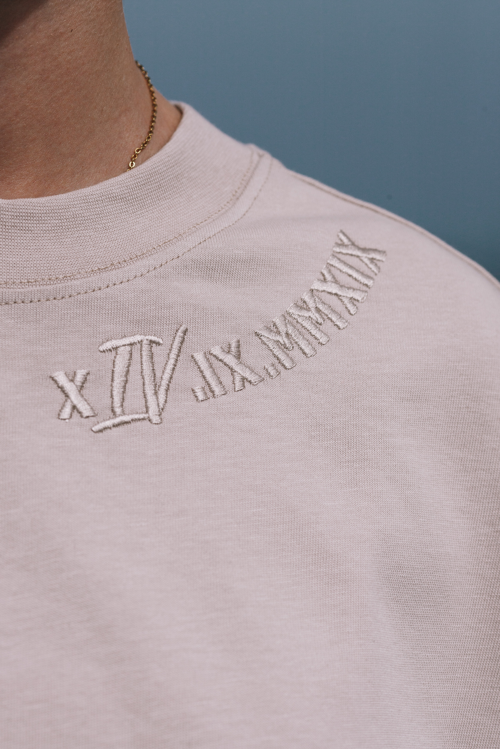 Collar embroidery on the beige tee, tonal thread on tonal cotton, close detail