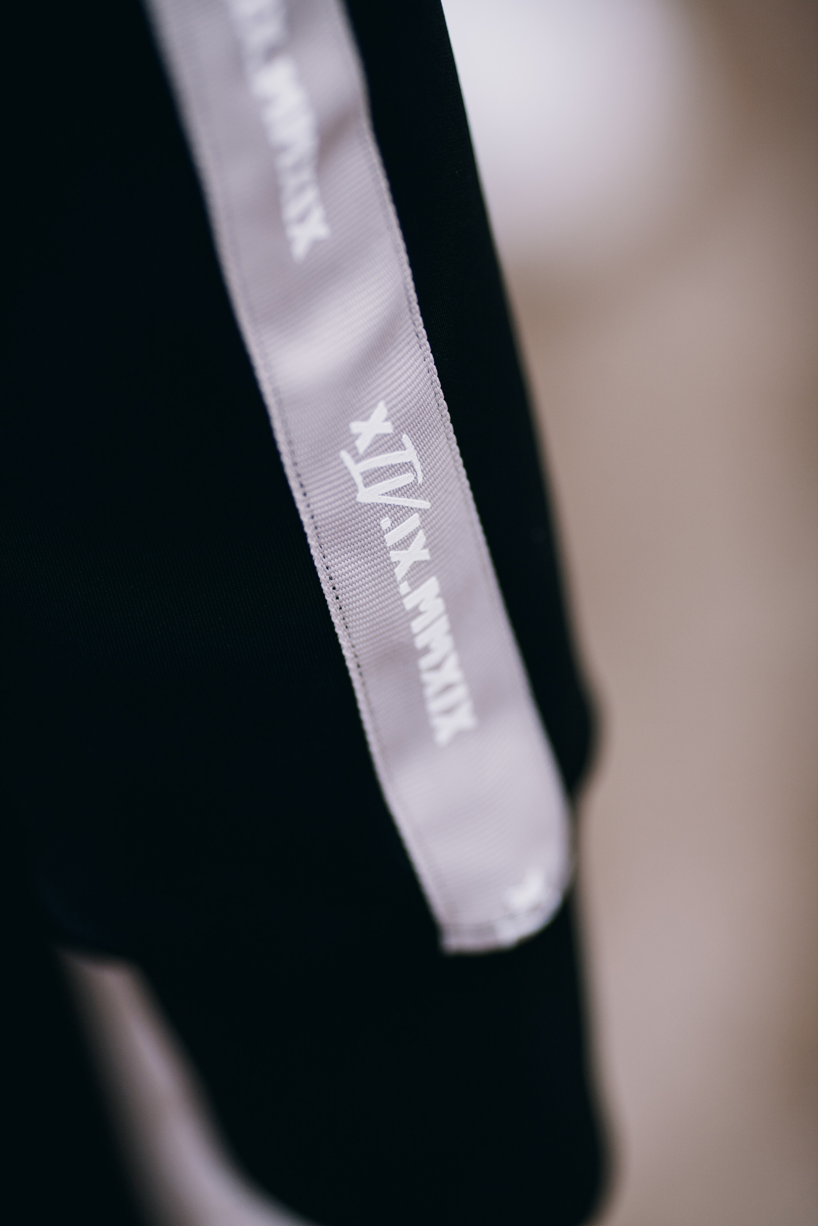 Stripe of the track jacket in close detail, tonal tape on black