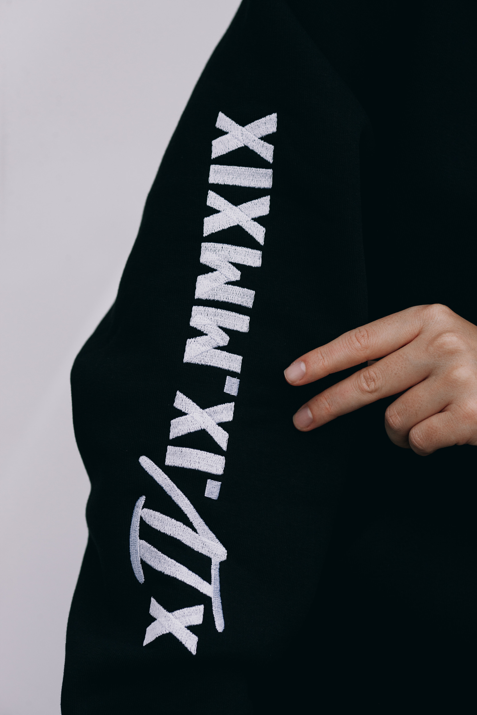 Roman numeral print along the hoodie sleeve, close detail