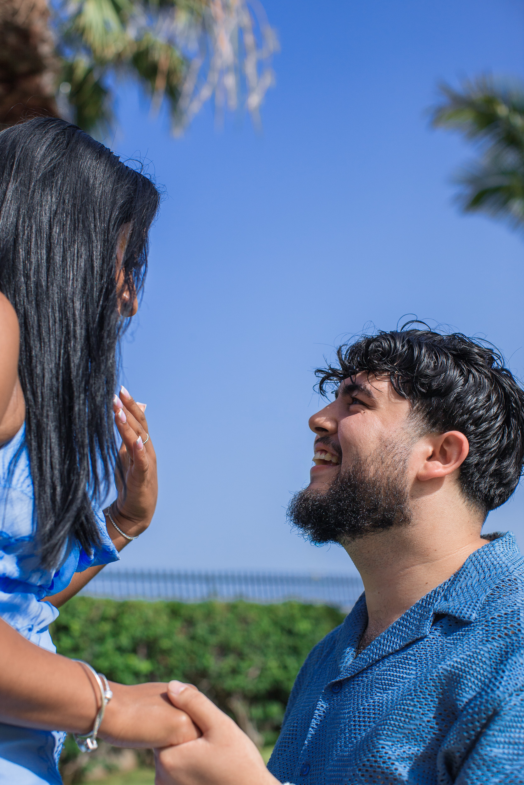 Looking up at her from one knee, both laughing, proposal in Funchal, Madeira