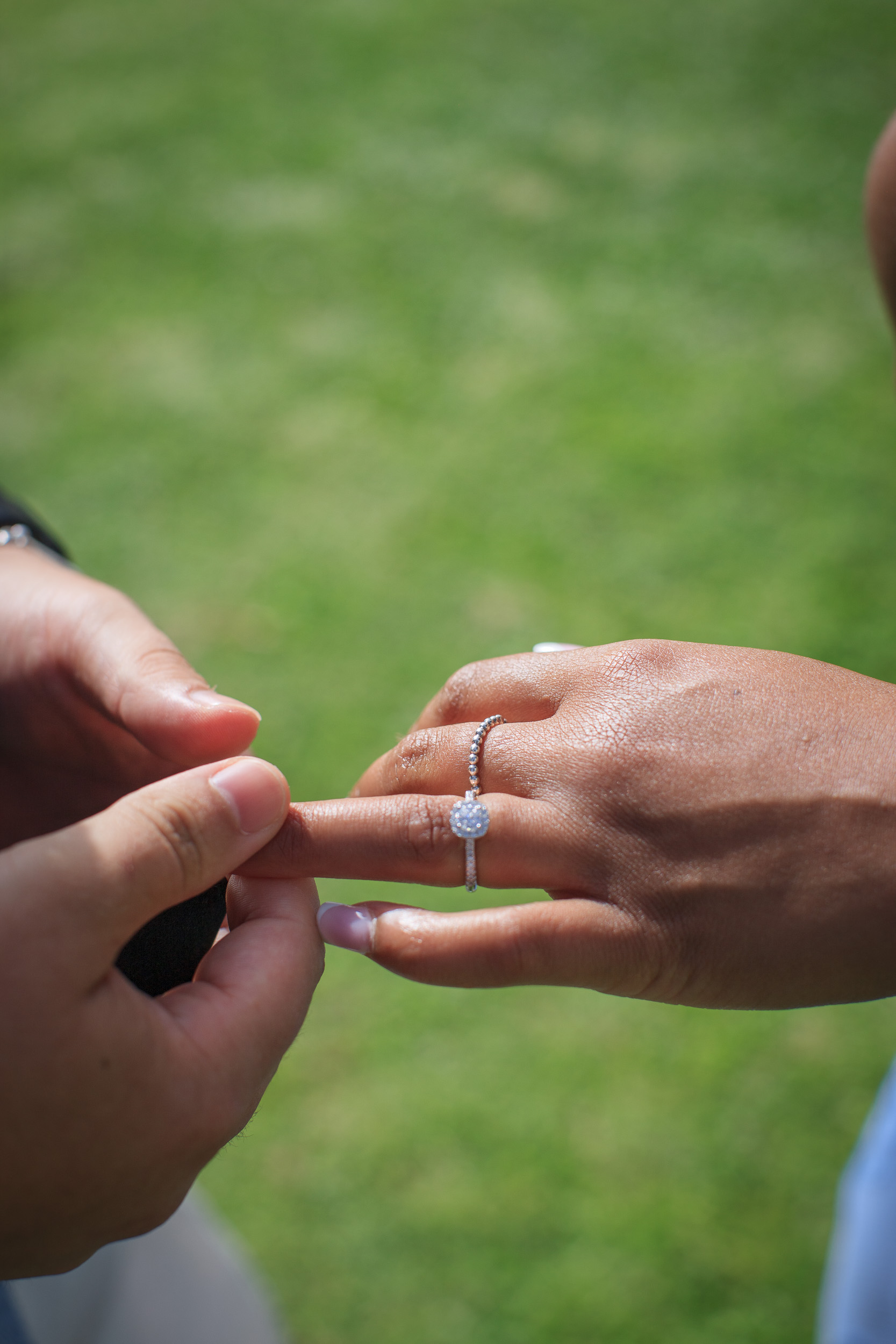 Close-up of the diamond ring going onto her hand, proposal on Madeira