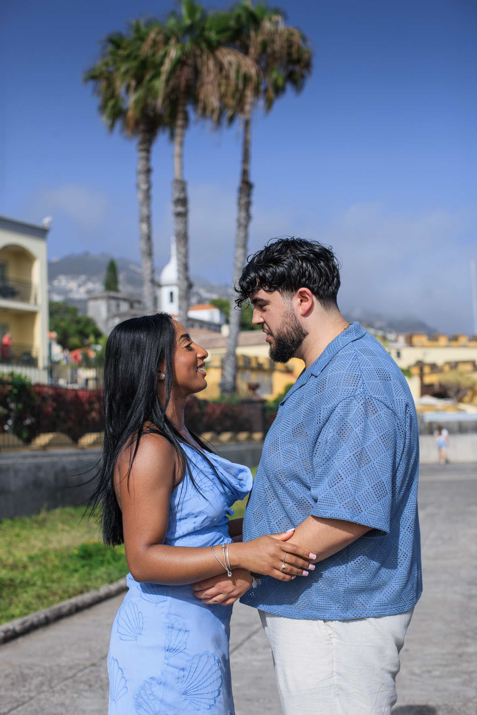 Holding each other on the promenade with the church tower behind, Funchal, Madeira