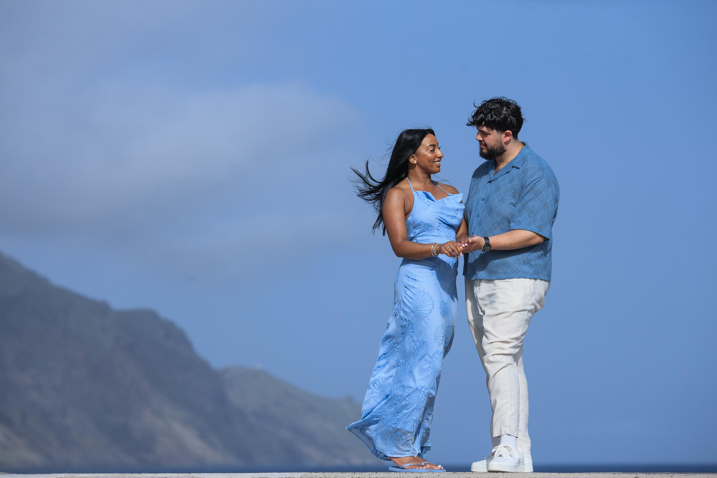 Holding each other on the seawall, engaged in Funchal, Madeira