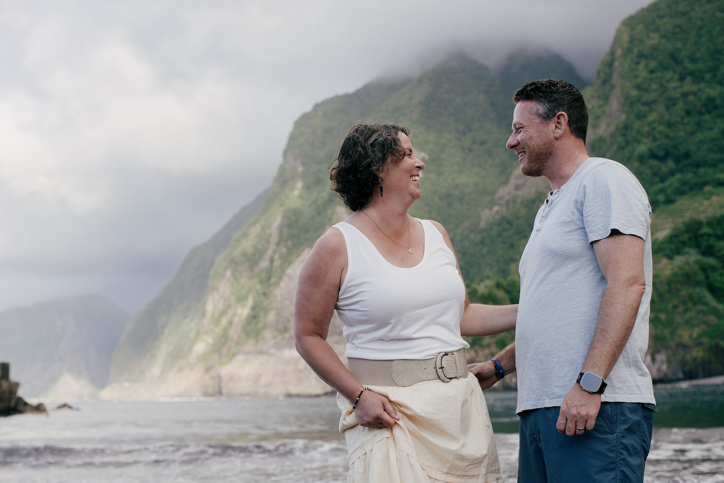 The parents face to face on the shore, mist on the peaks behind, Seixal, Madeira
