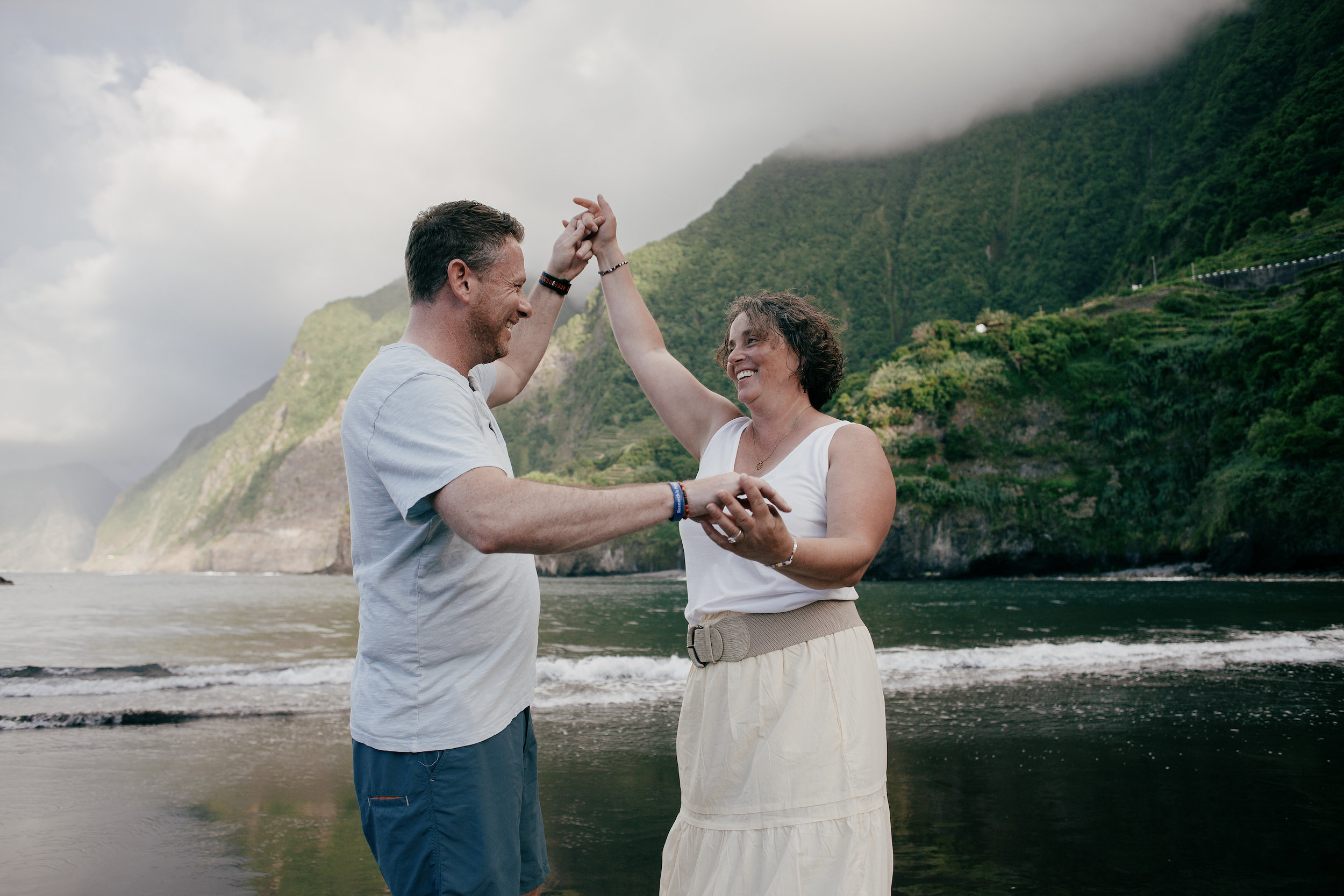 Dancing together on the beach below the cliffs, Seixal, Madeira