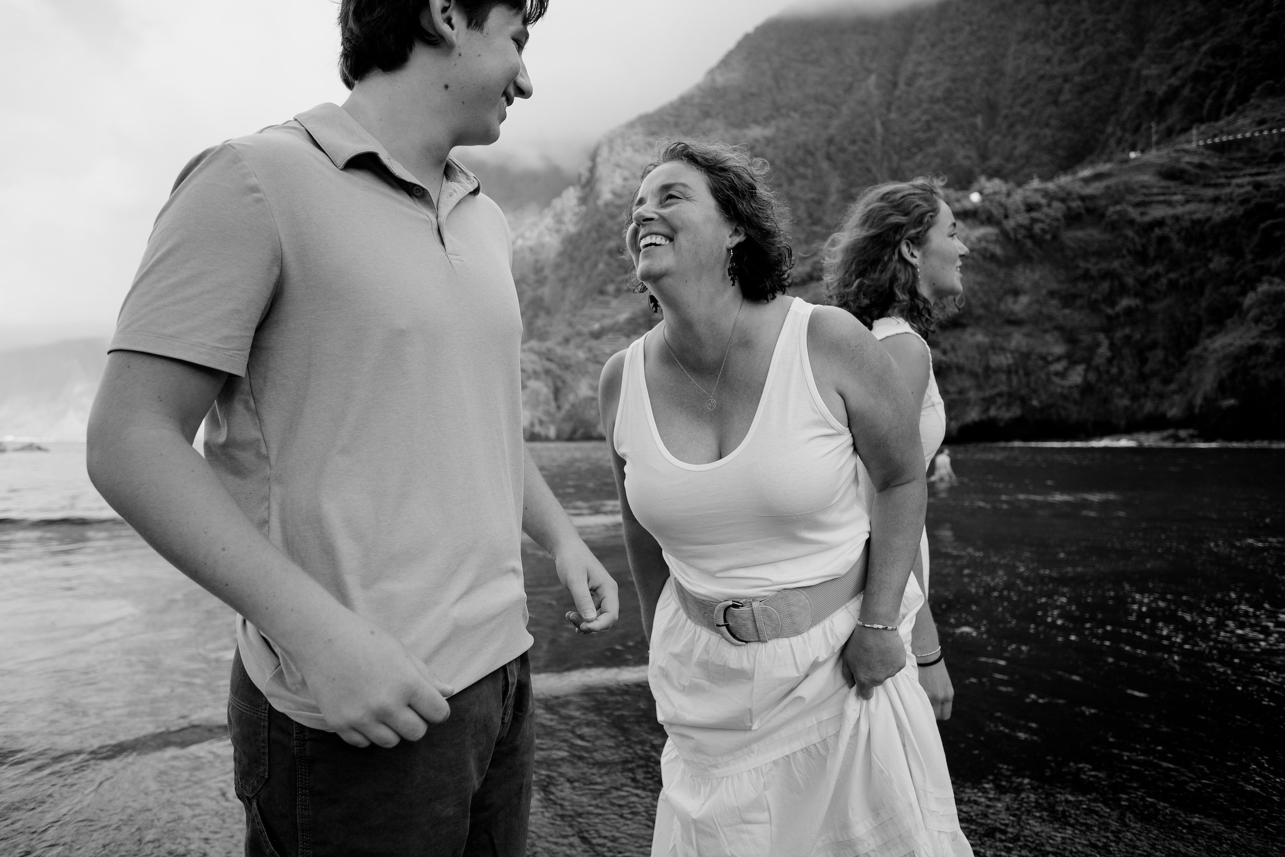 Black and white laughter between son, mother and daughter at the shore, Seixal, Madeira