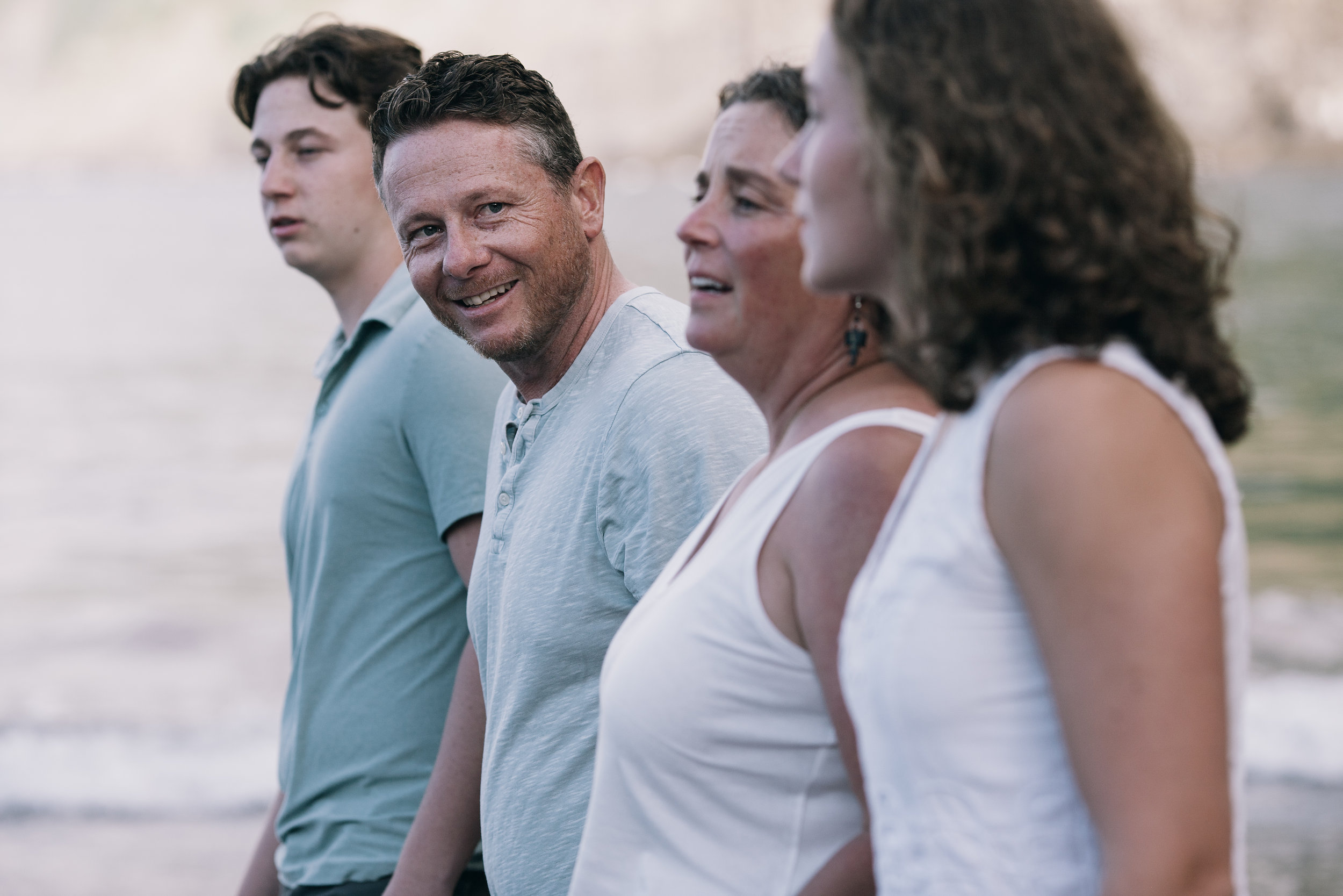 Family close together in profile against the sea, Seixal Beach, Madeira