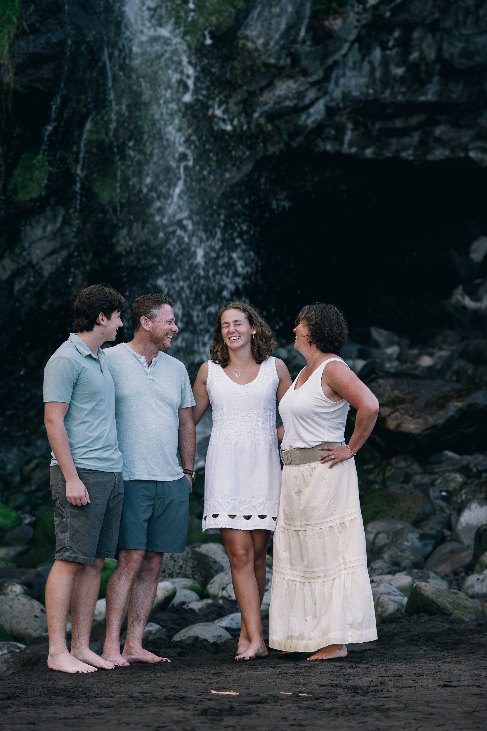 Standing beneath the cliffside waterfall at the end of Seixal Beach, Madeira
