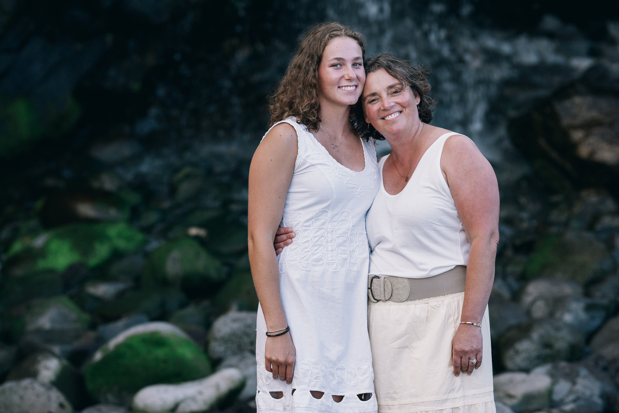 Daughter and mother cheek to cheek by the mossy rocks, Seixal, Madeira