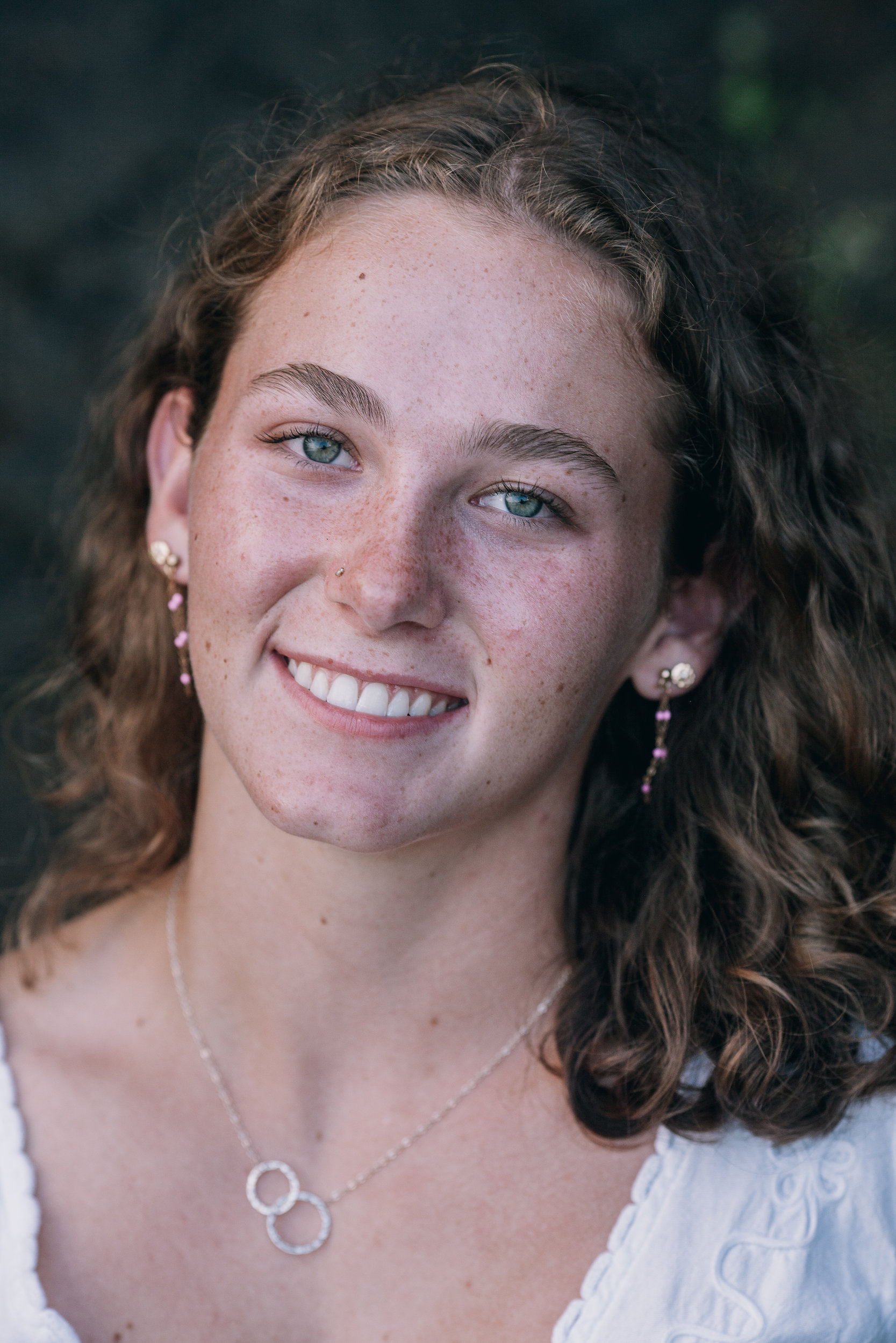 Close portrait of the daughter with freckles and pearl earrings, Seixal, Madeira
