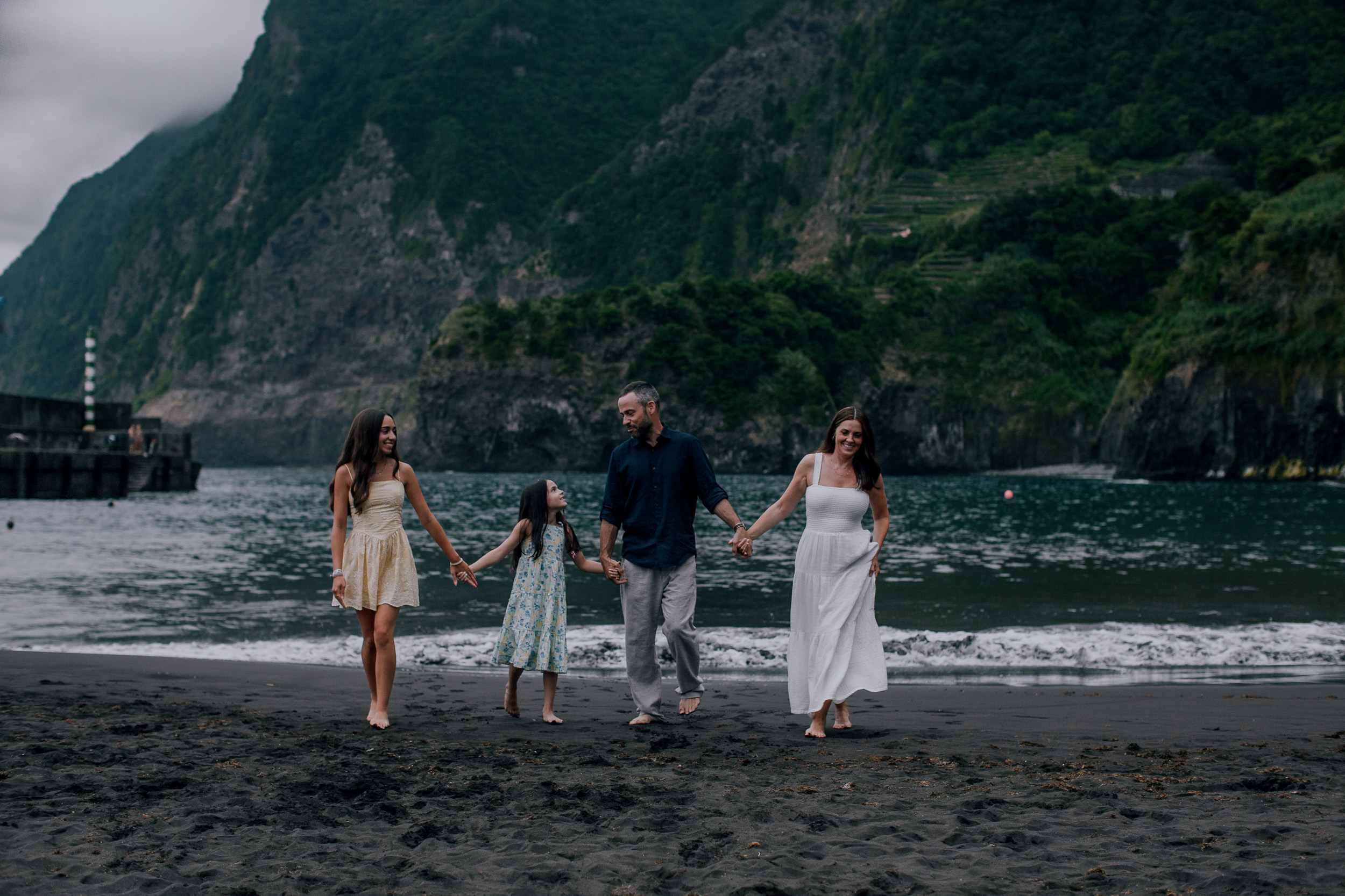 Walking the tide line together on the dark sand, Seixal, Madeira