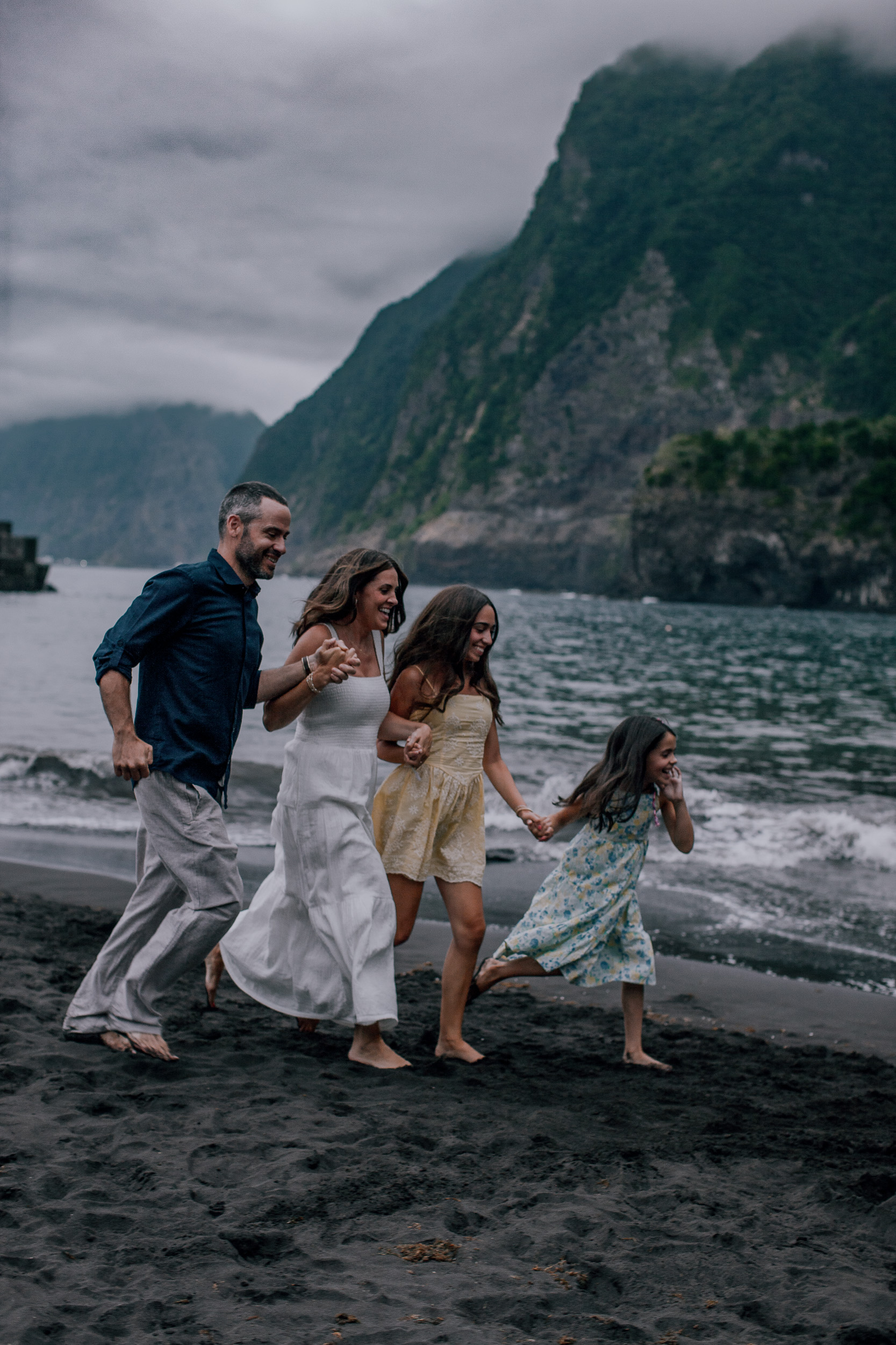 Running together toward the water laughing, Seixal Beach, Madeira