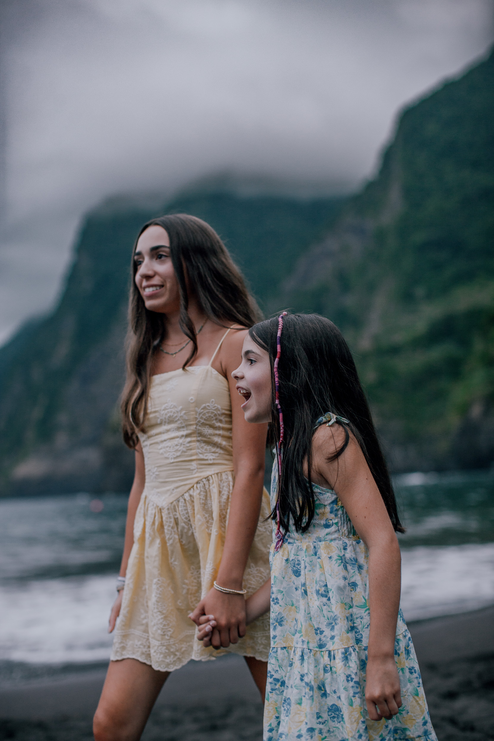 The teenage sister whispering to the younger one, Seixal Beach, Madeira