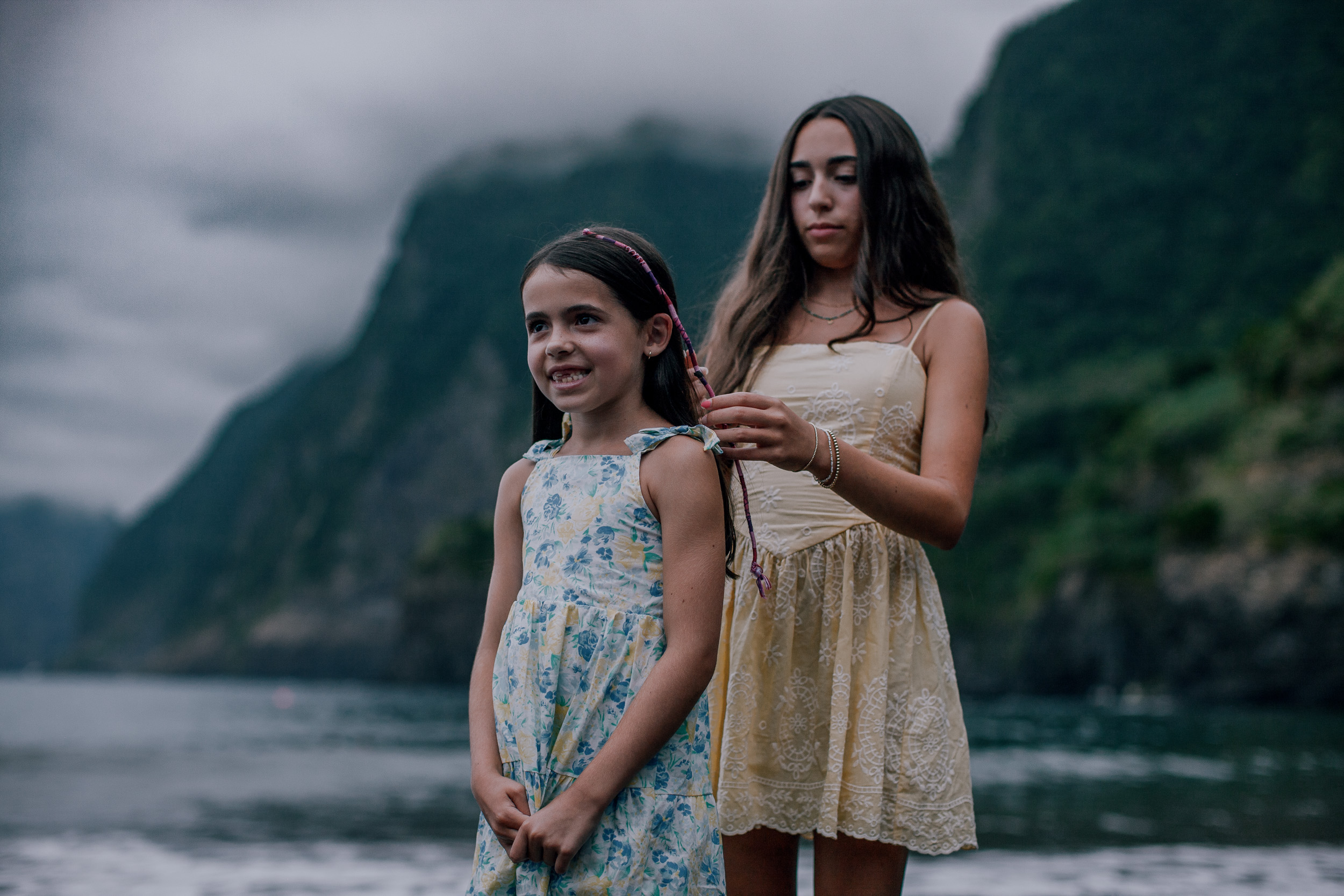 The sisters side by side against the misty cliffs, Seixal, Madeira