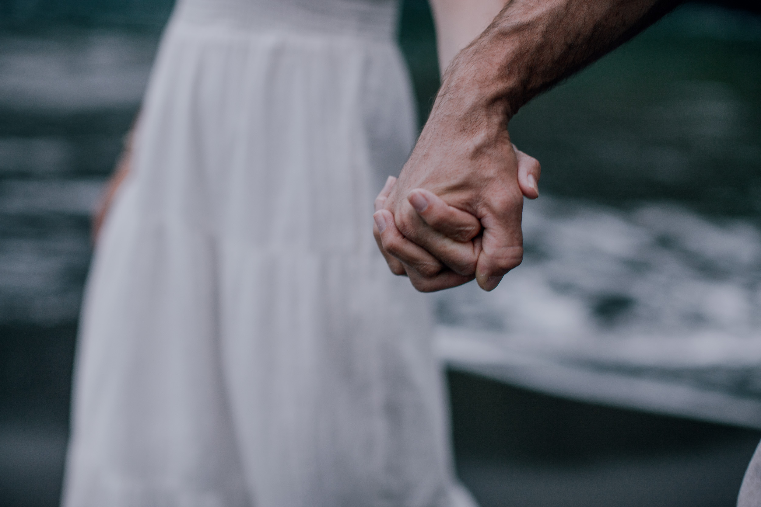 Their hands linked over the white dress, detail from Seixal, Madeira