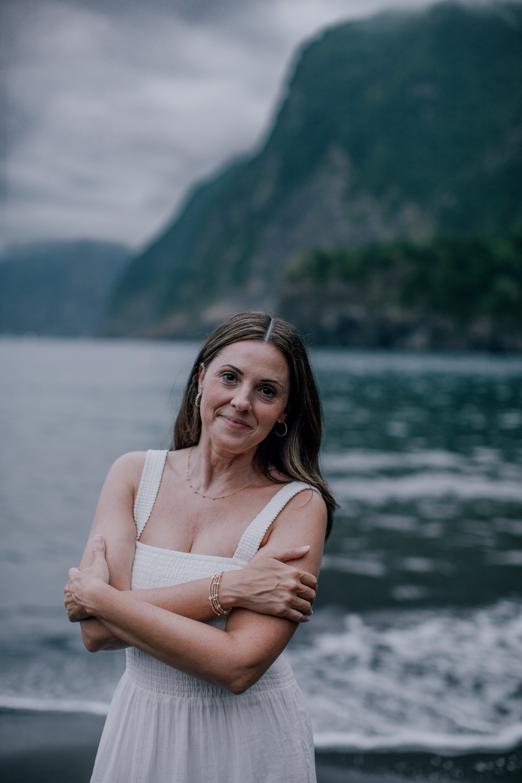 The mother wrapped in her own arms smiling, Seixal Beach, Madeira
