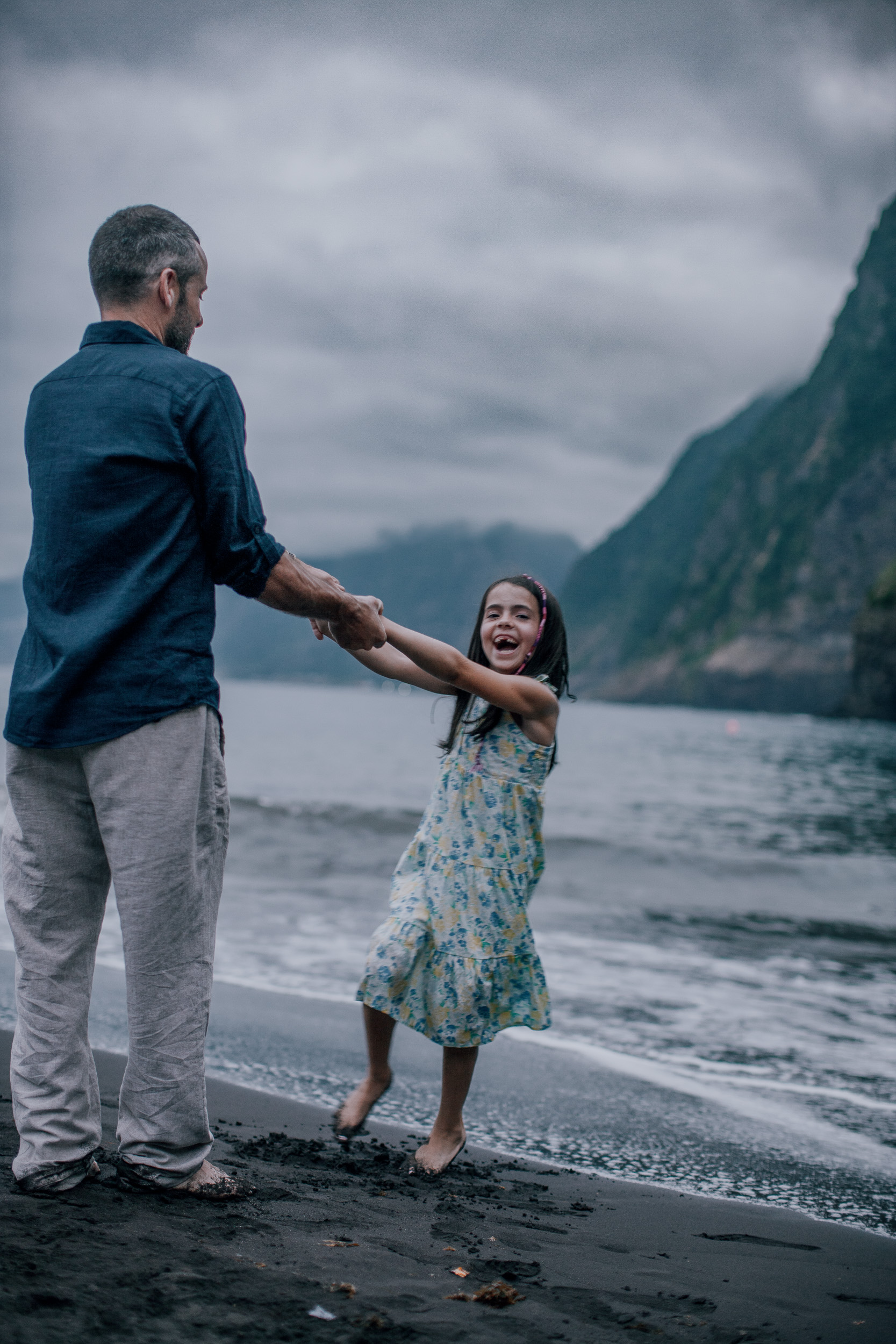 Dad spinning the younger daughter by her arms, Seixal Beach, Madeira