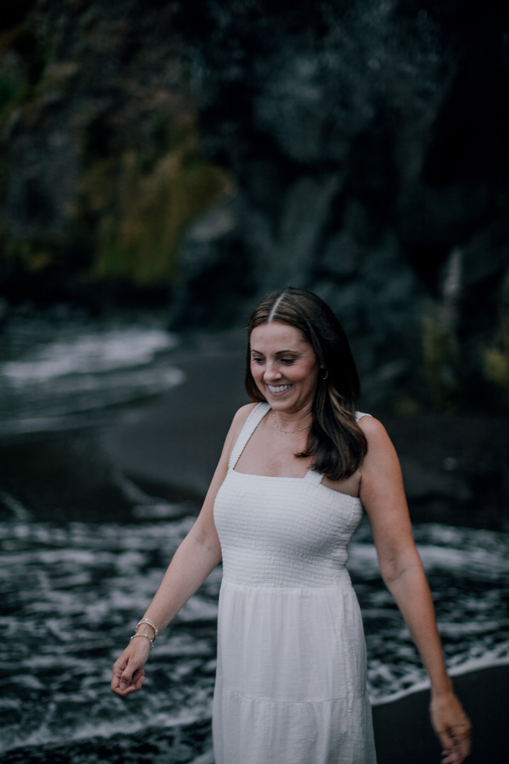 Mum walking the dark waterline smiling, Seixal Beach, Madeira