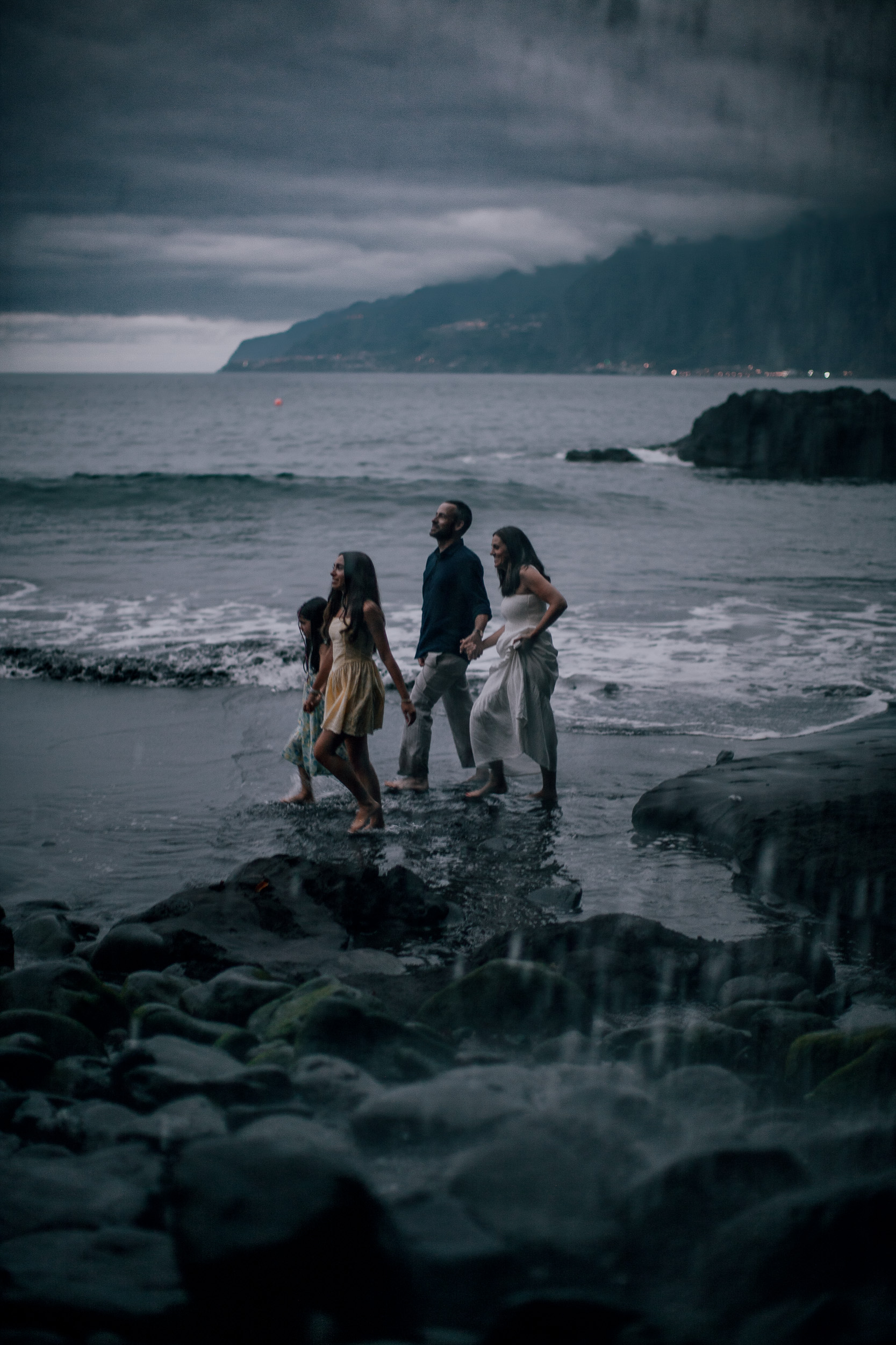 The family picking through the boulders at nightfall, Seixal, Madeira
