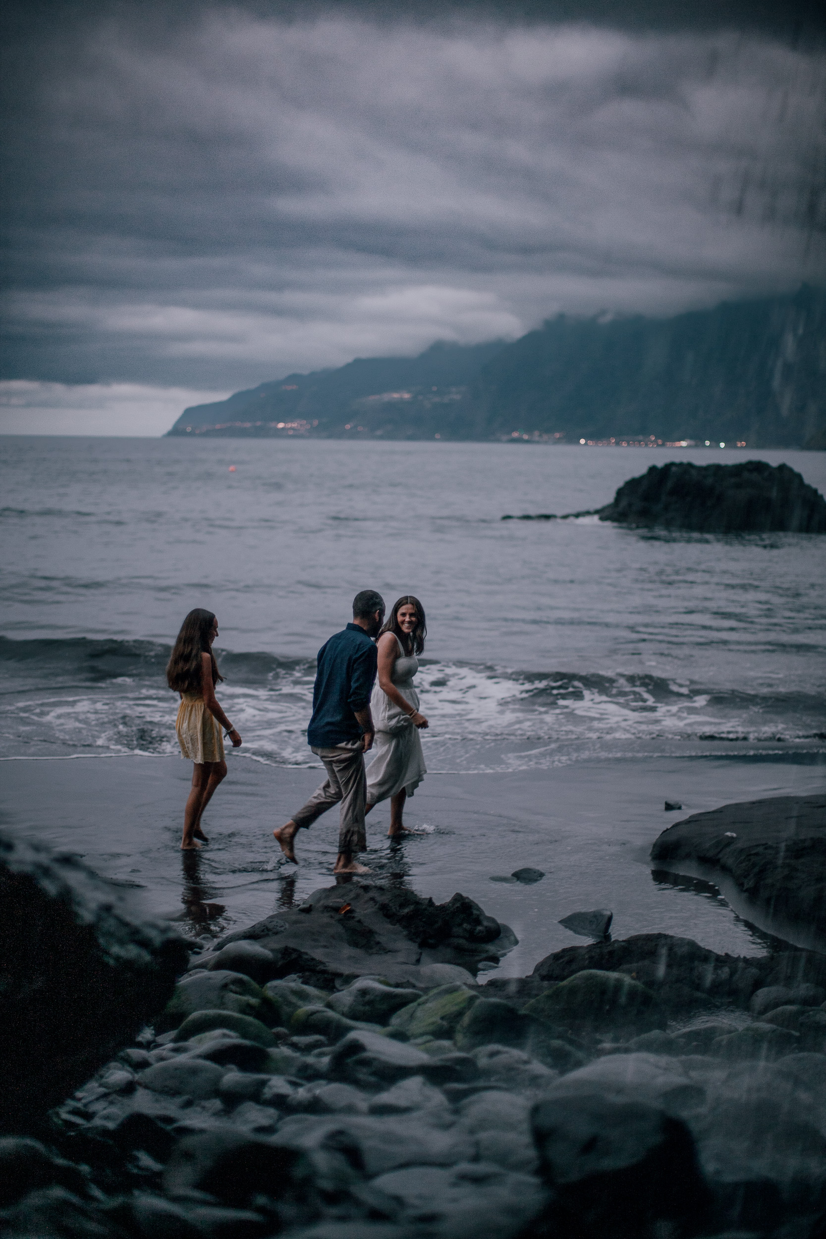 The parents in the surf at last light, Seixal Beach, Madeira