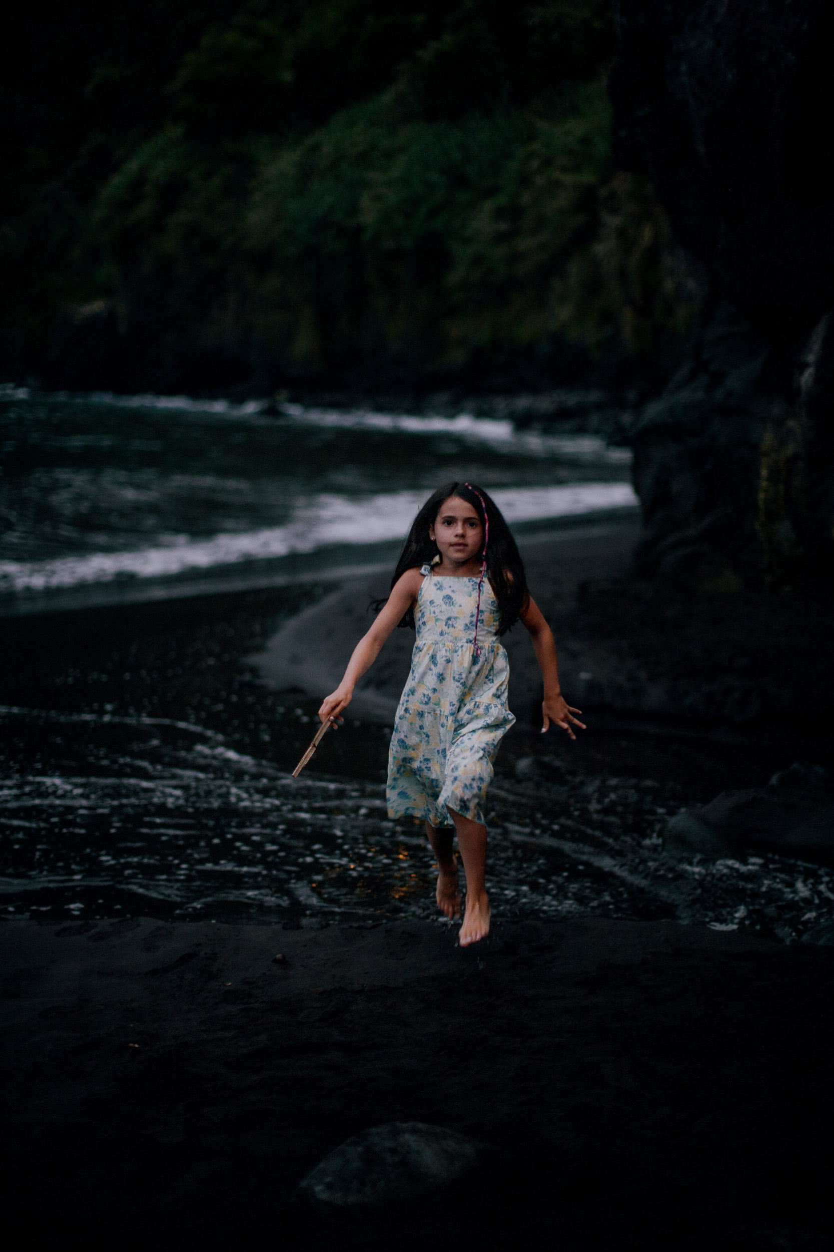 The younger daughter skipping through the dark sand, Seixal, Madeira