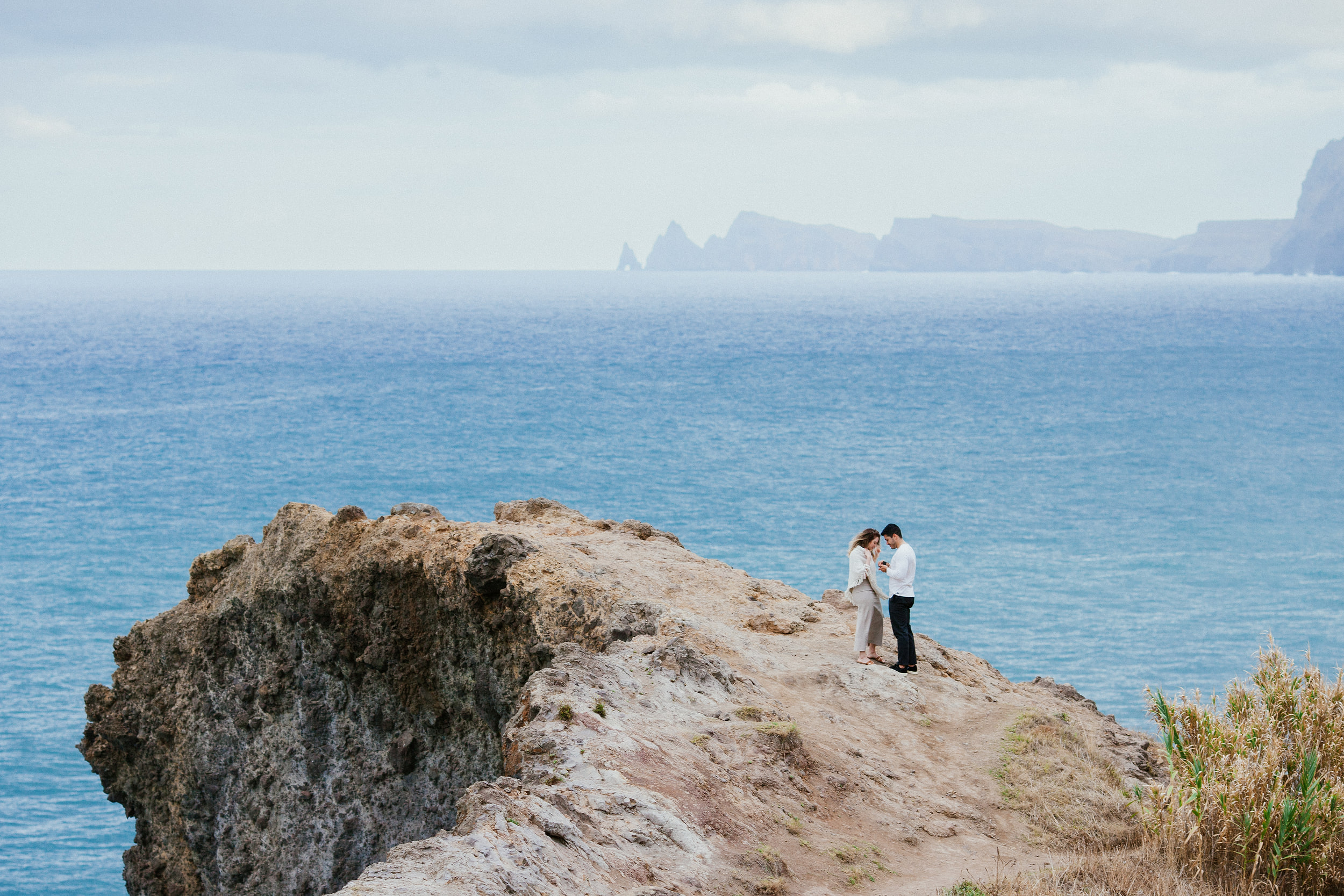 Lucas and Isabela standing together at the end of the ledge right after the yes, Miradouro do Guindaste, Madeira