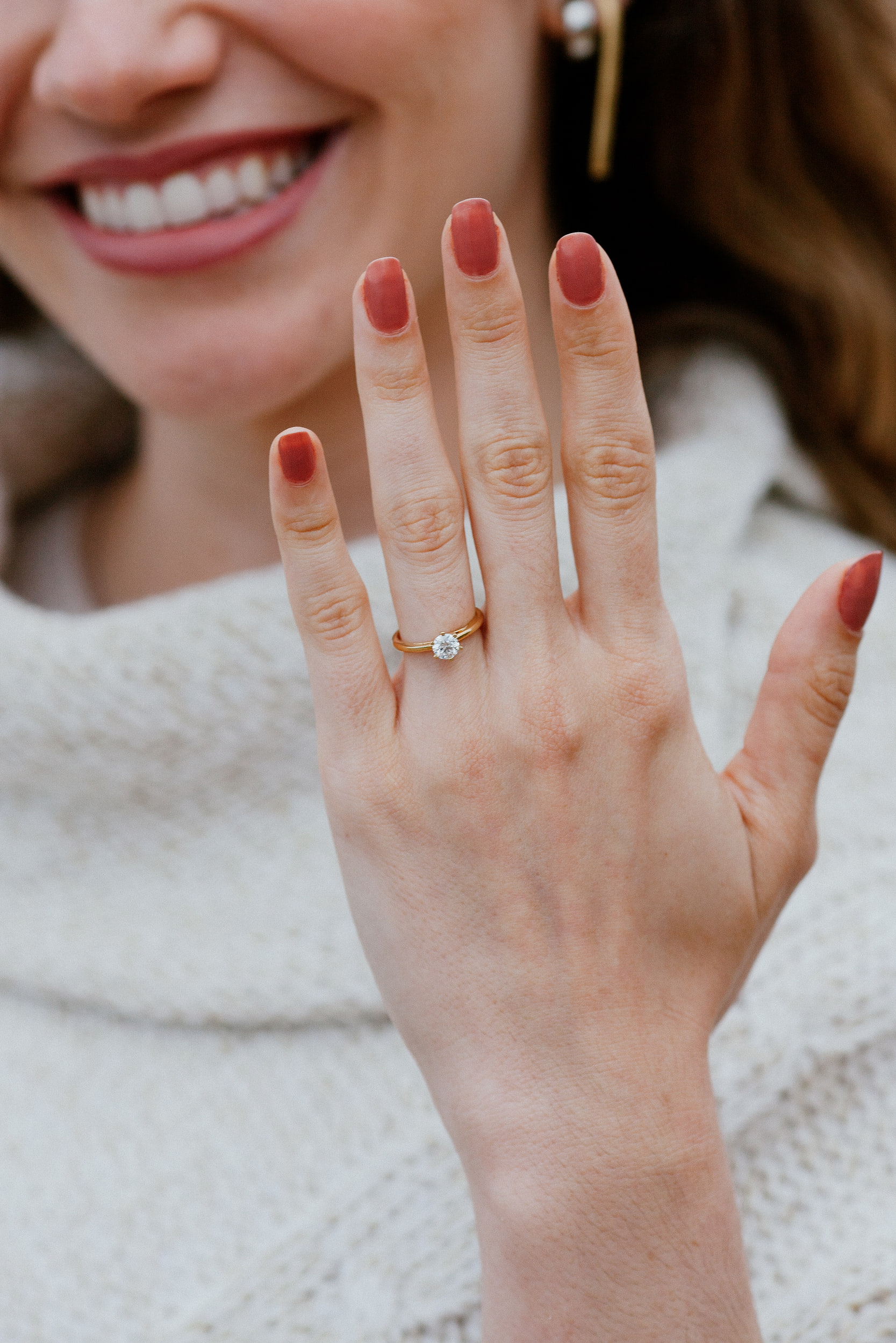 Detail of Isabela's smile and her raised hand with the ring, Miradouro do Guindaste, Madeira