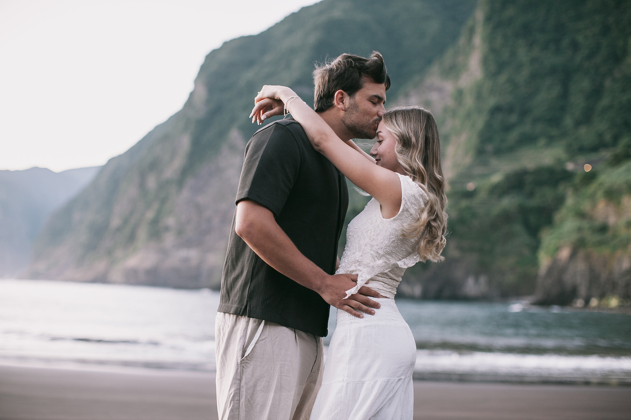 A kiss with the north coast cliffs rising behind, Seixal, Madeira