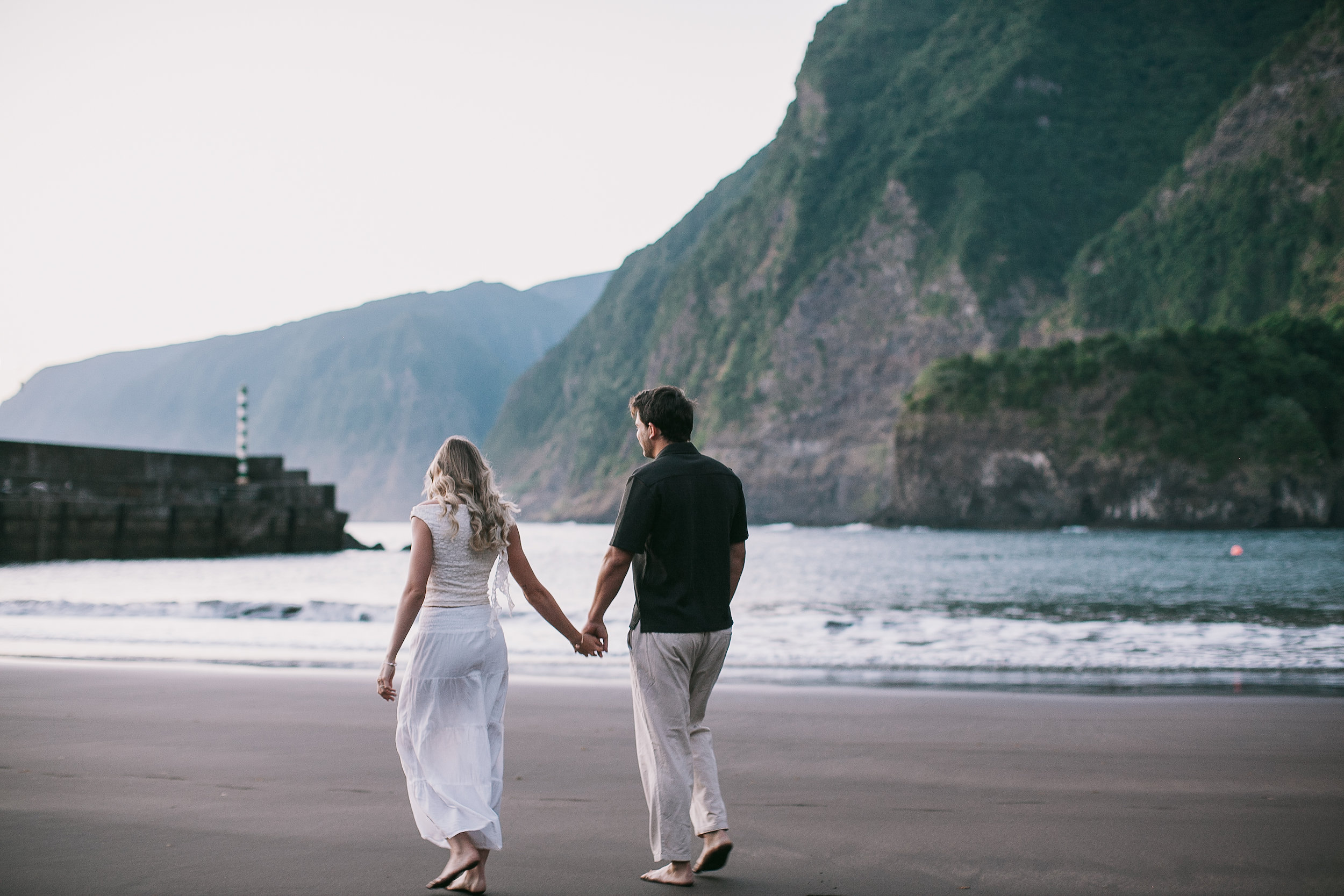 Strolling toward the harbor pier below the cliffs, Seixal, Madeira