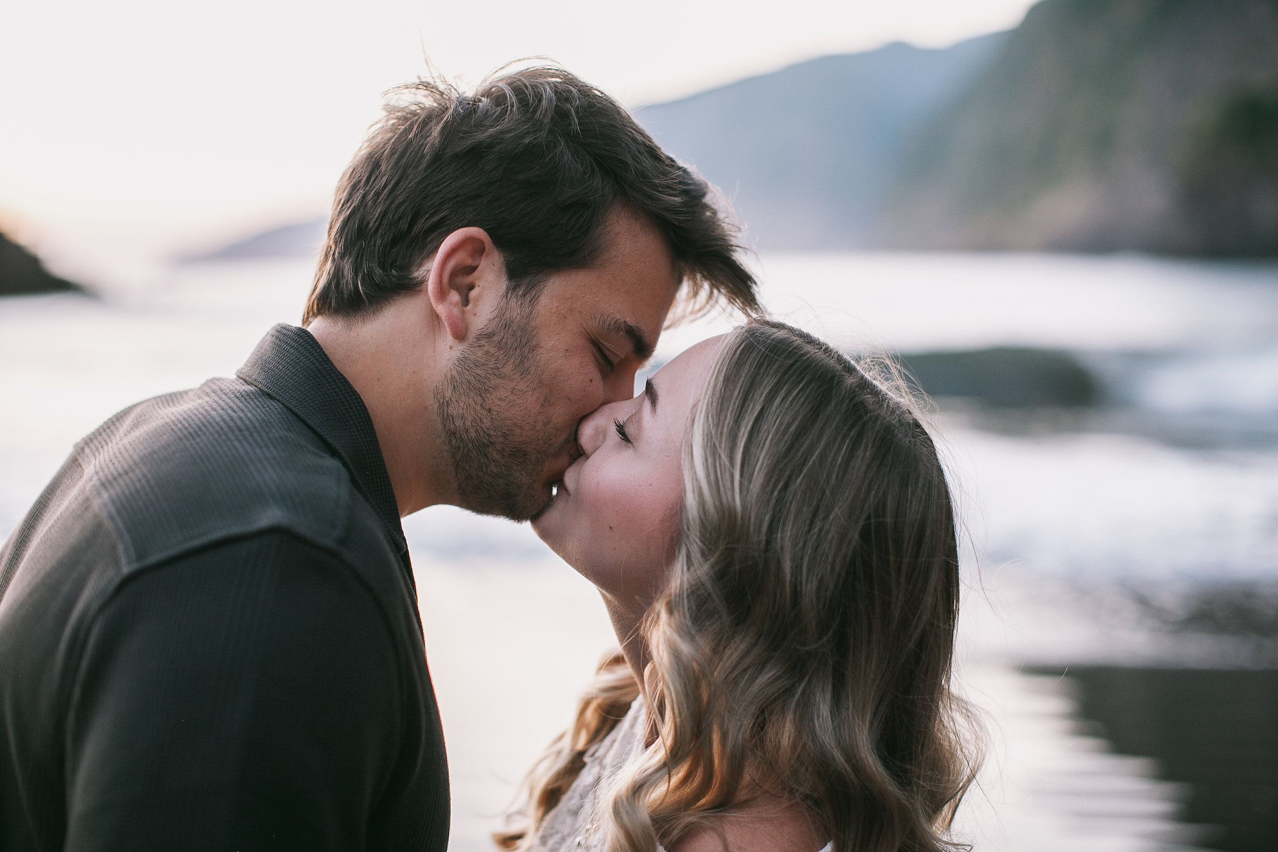 A kiss in the soft evening light at the shore, Seixal Beach, Madeira
