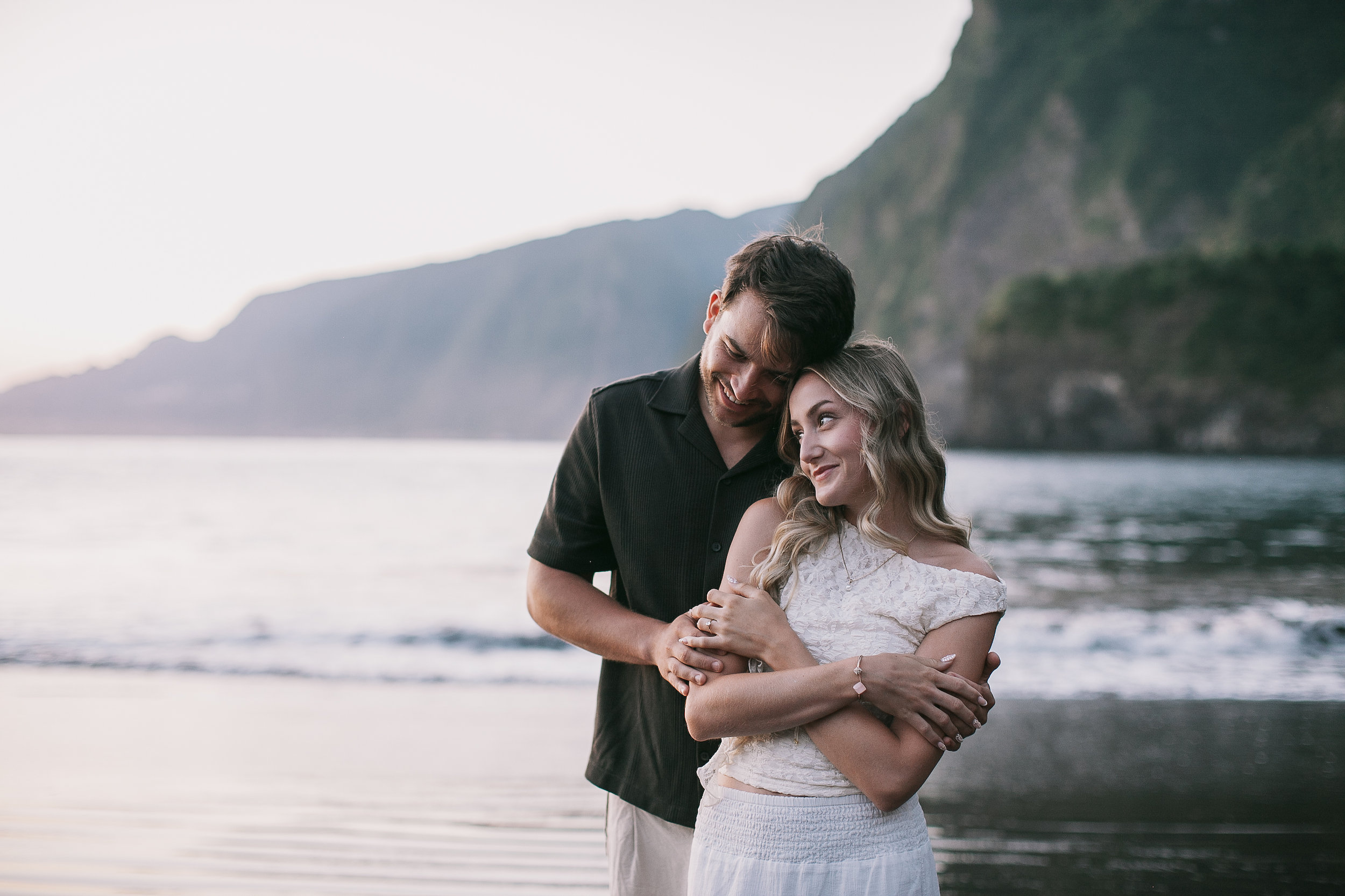 Held from behind at the waterline, both smiling, Seixal Beach, Madeira