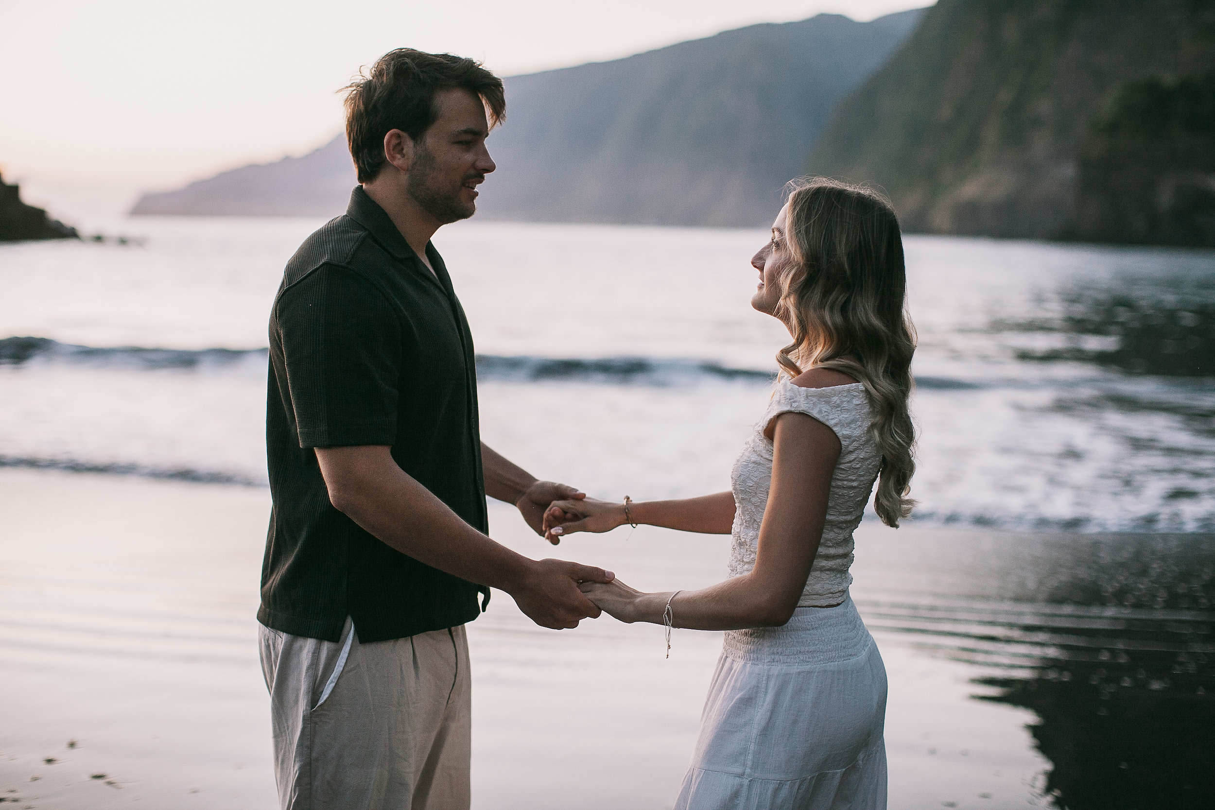Holding both hands face to face at the sea, Seixal, Madeira