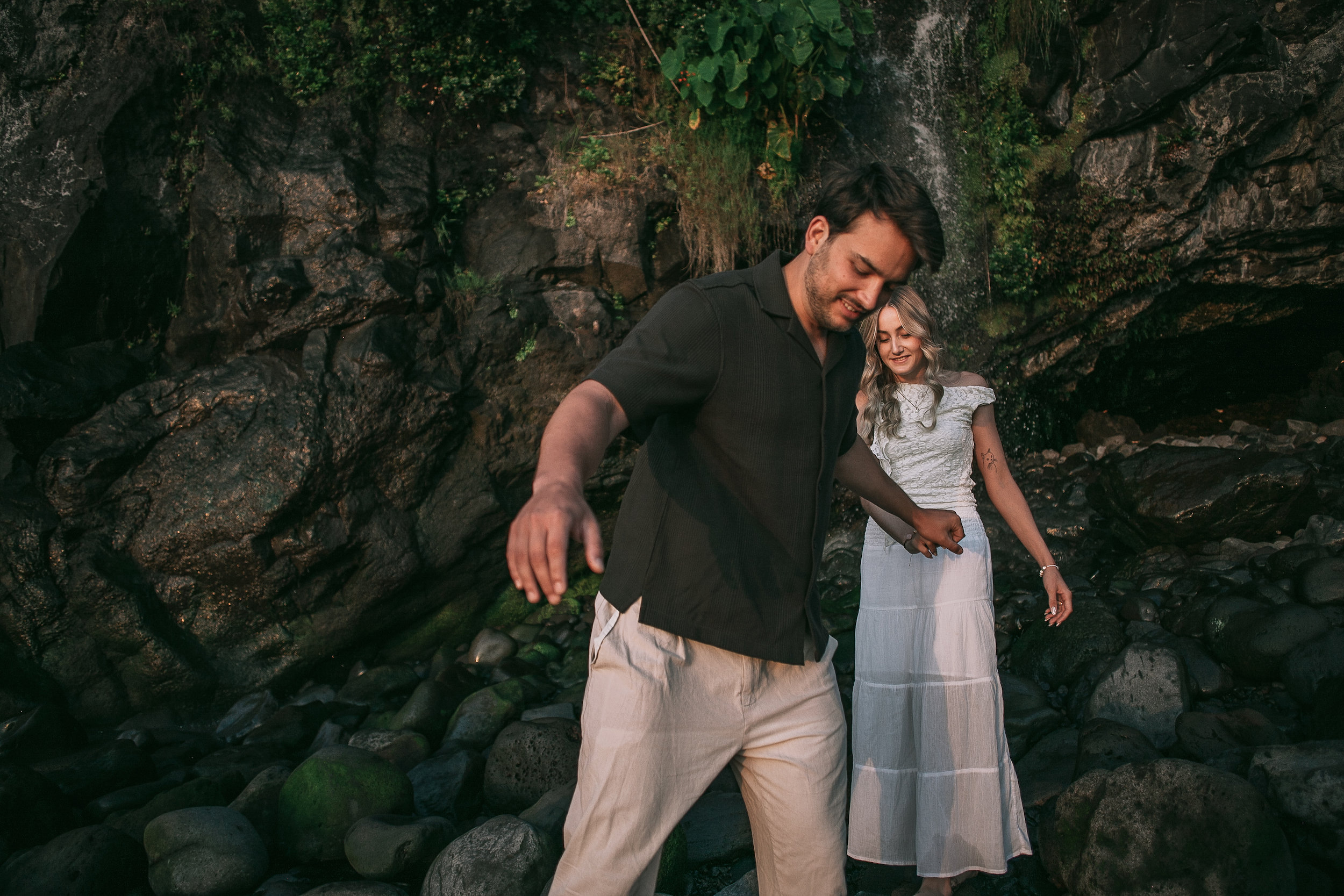 Laughing together under the thin waterfall at Seixal, Madeira