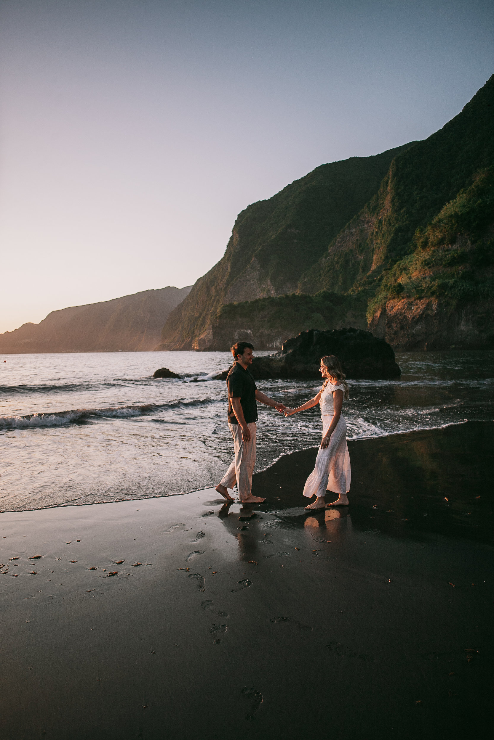 Walking the wet sand at sunset below the cliffs, Seixal Beach, Madeira