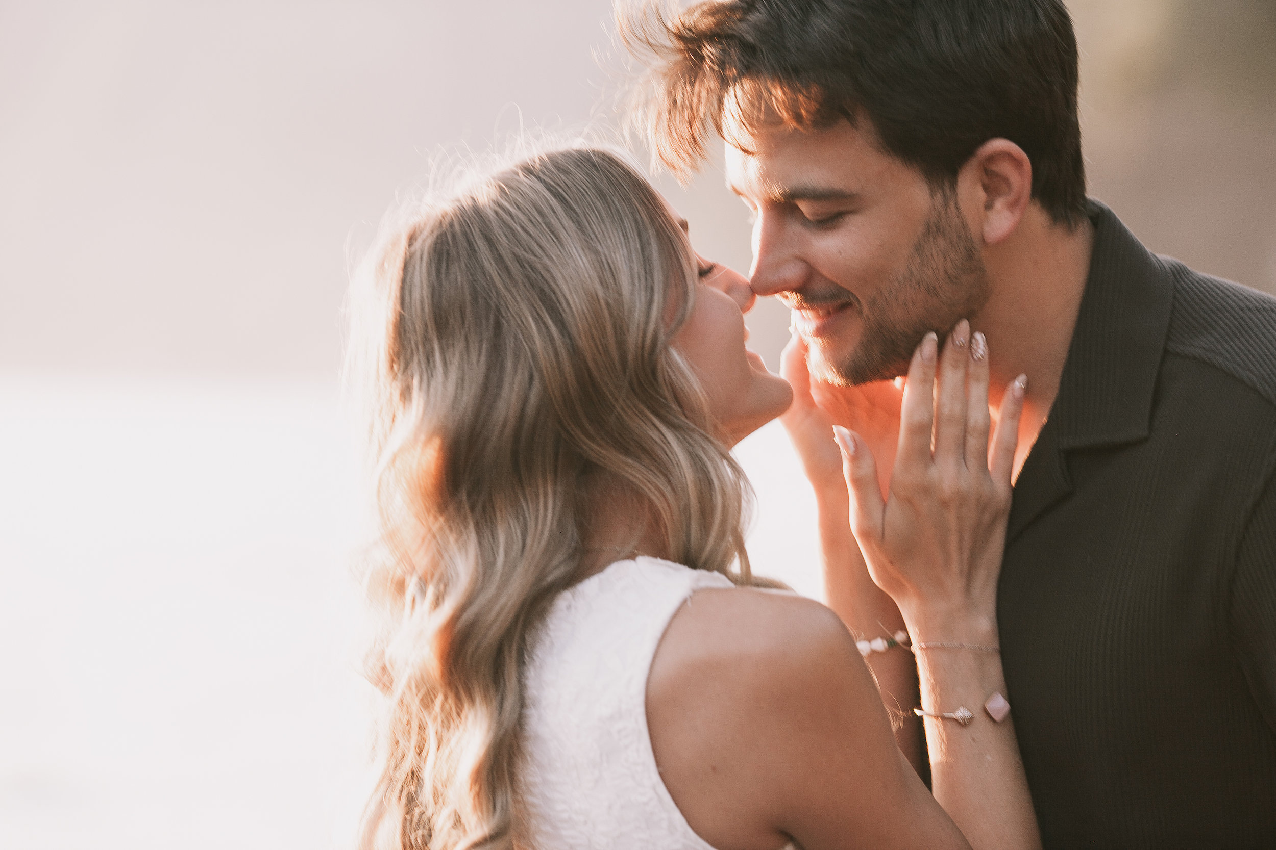 Nose to nose with her hands at his face, golden hour at Seixal, Madeira
