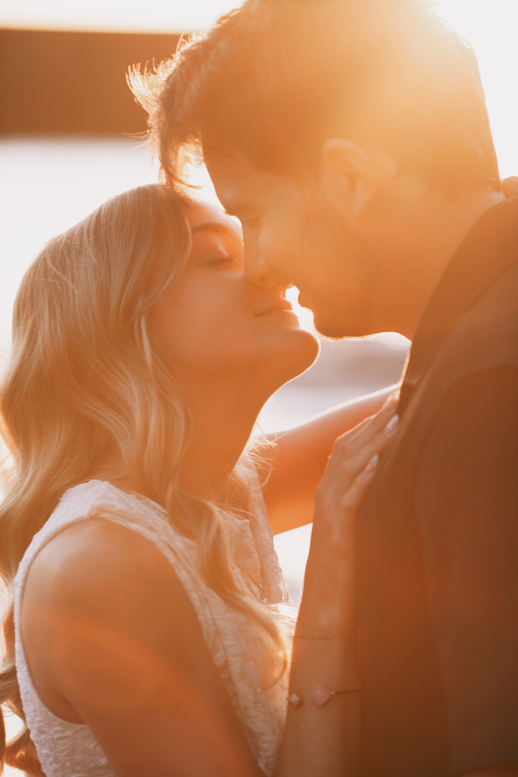 Sun flare over a kiss at golden hour, Seixal Beach, Madeira